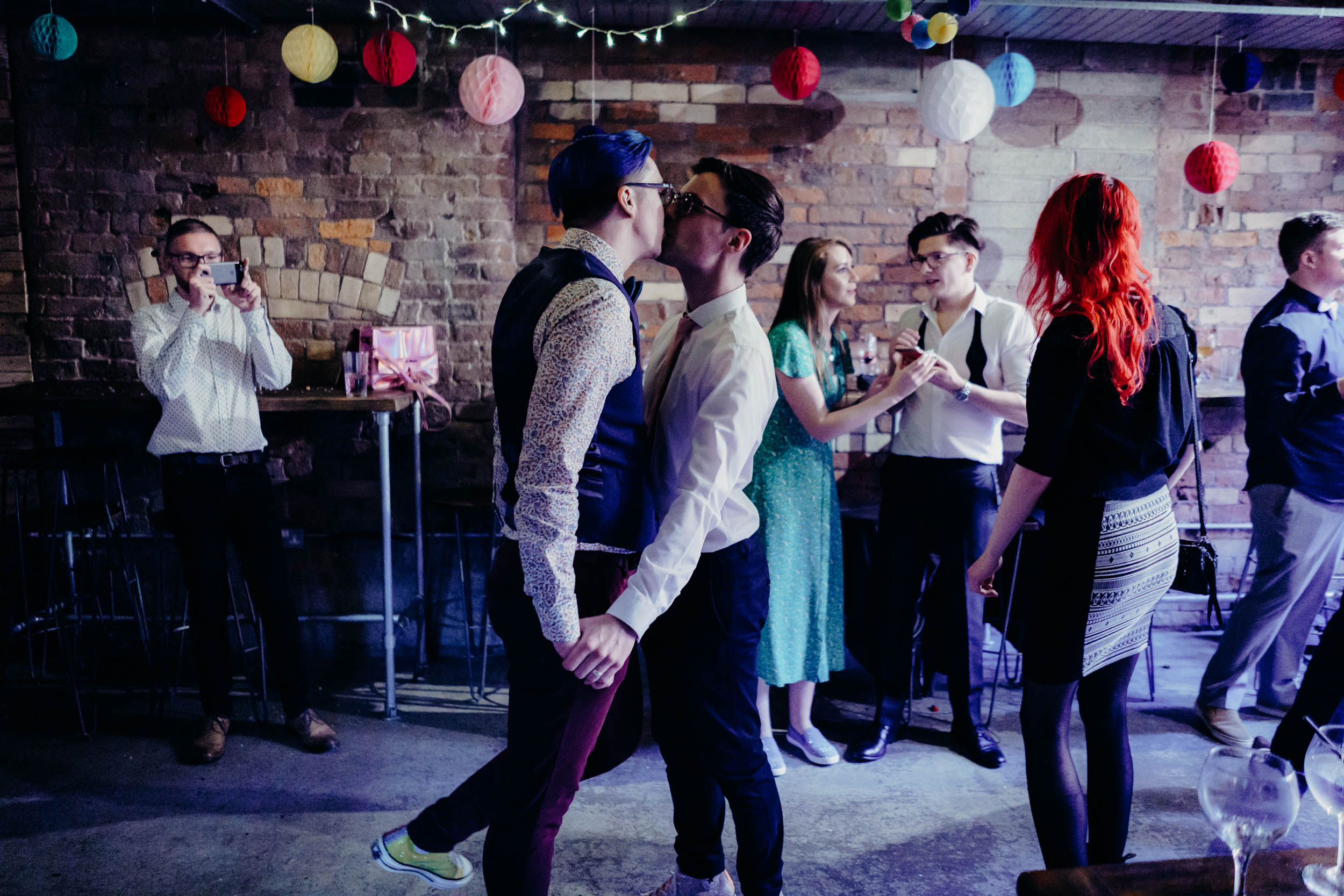 Mark and Tim kissing at their same-sex wedding at Seven Brothers, Manchester