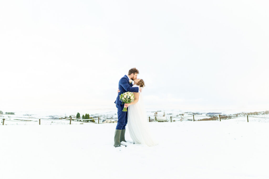Bride and groom kissing in the snow at the Grains Bar