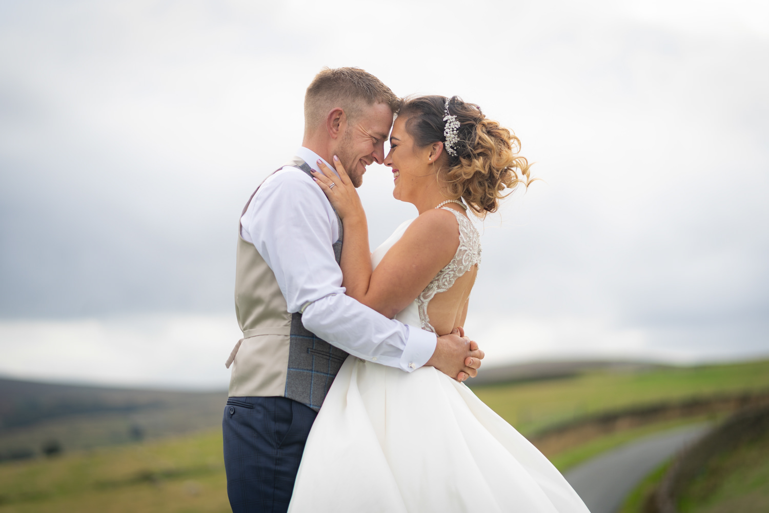 Bride and groom embracing outside