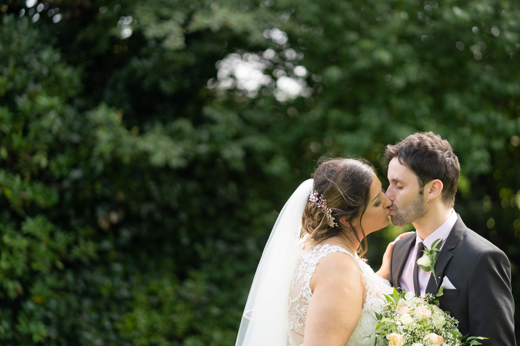 Bride and groom kissing at the Last Drop Hotel