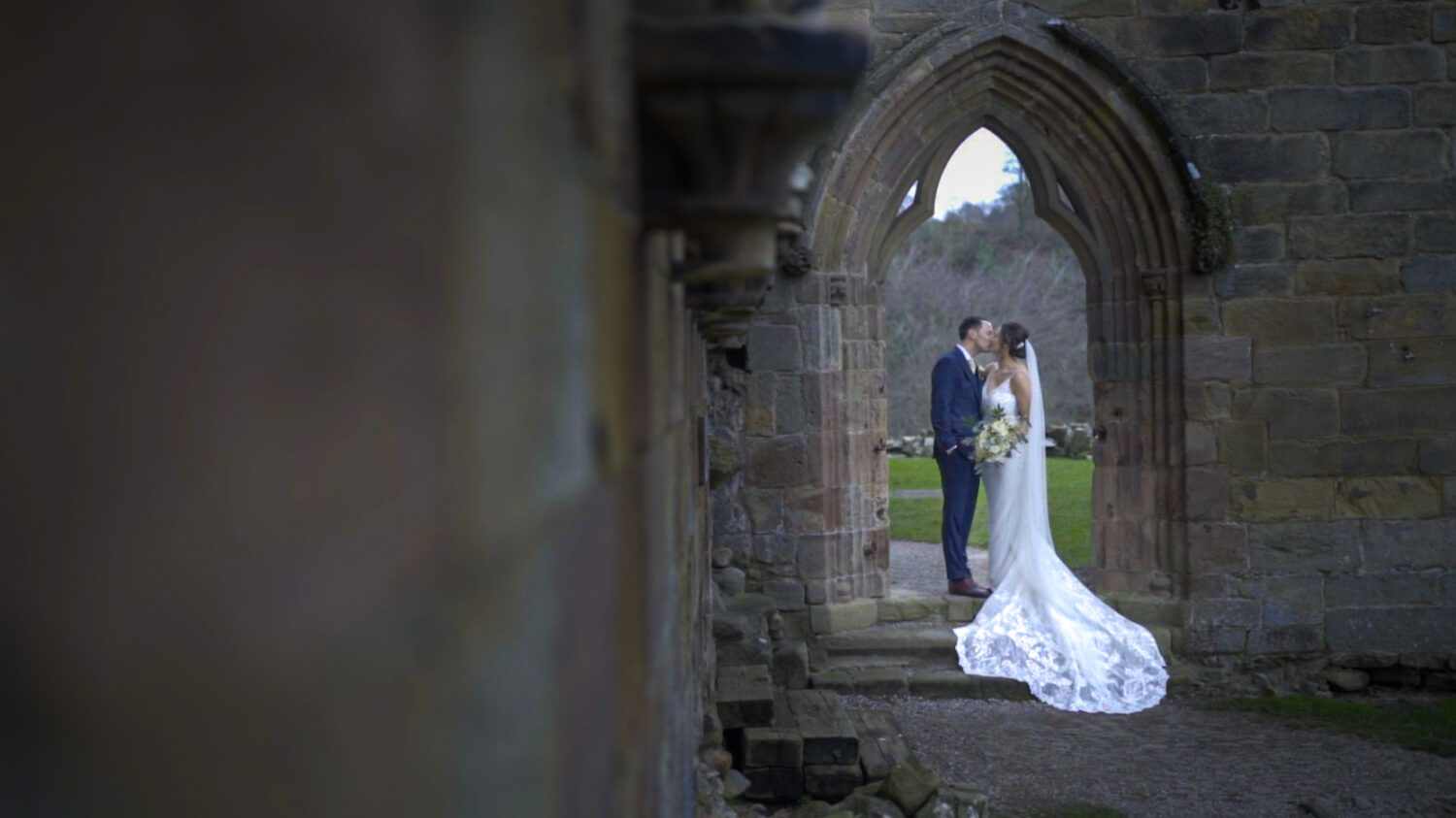 Bride and groom kissing at Bolton Abbey