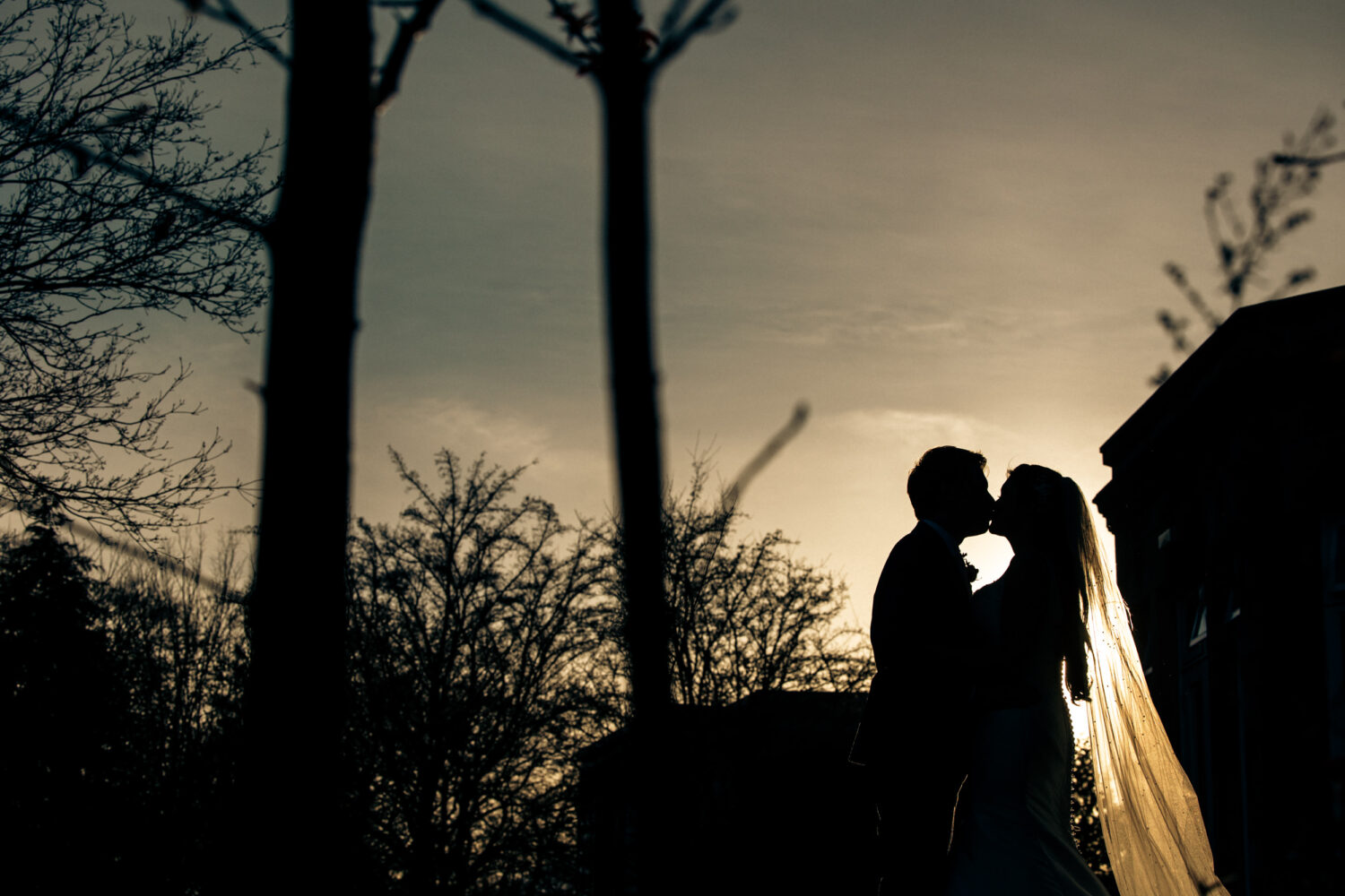 Silhouette of couple kissing at Halifax Hall