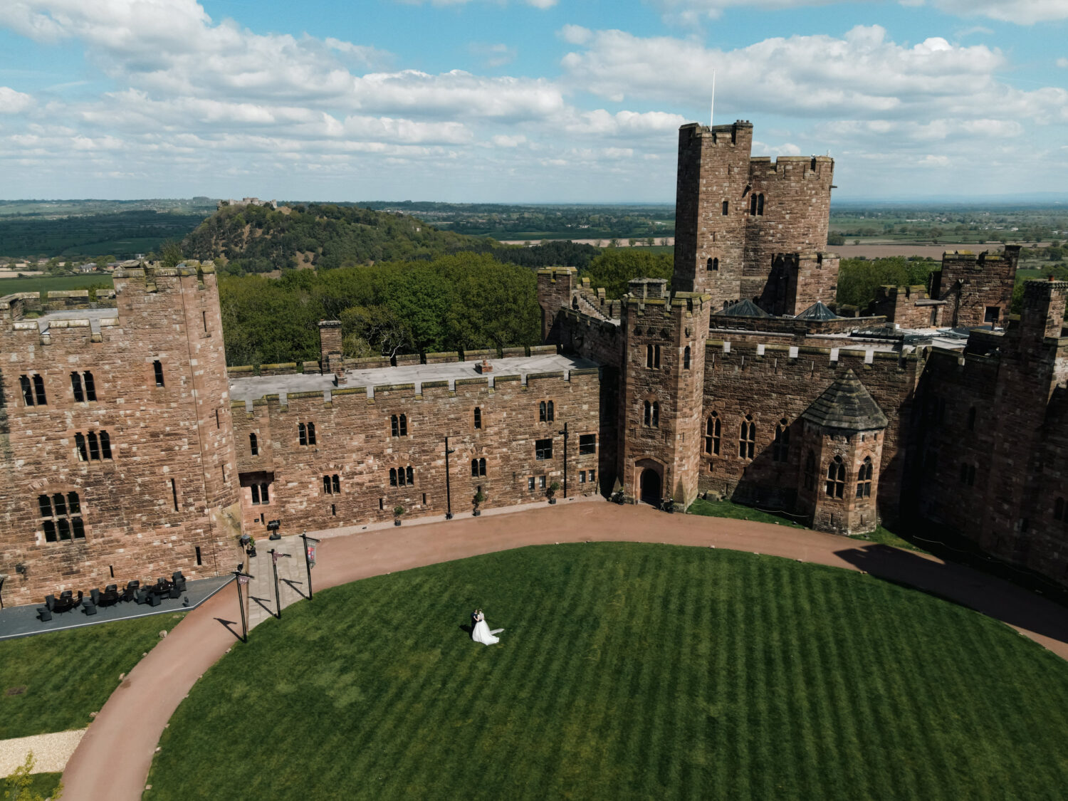 Wedding photograph of Peckforton Castle with Beeston Castle in the background.