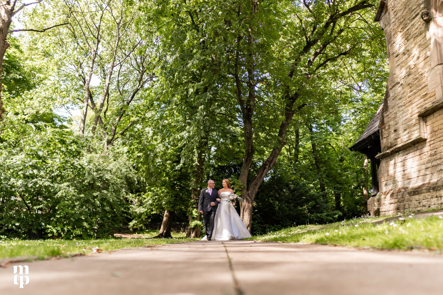 Bride and groom outside the church at this Manchester wedding in Chorlton.