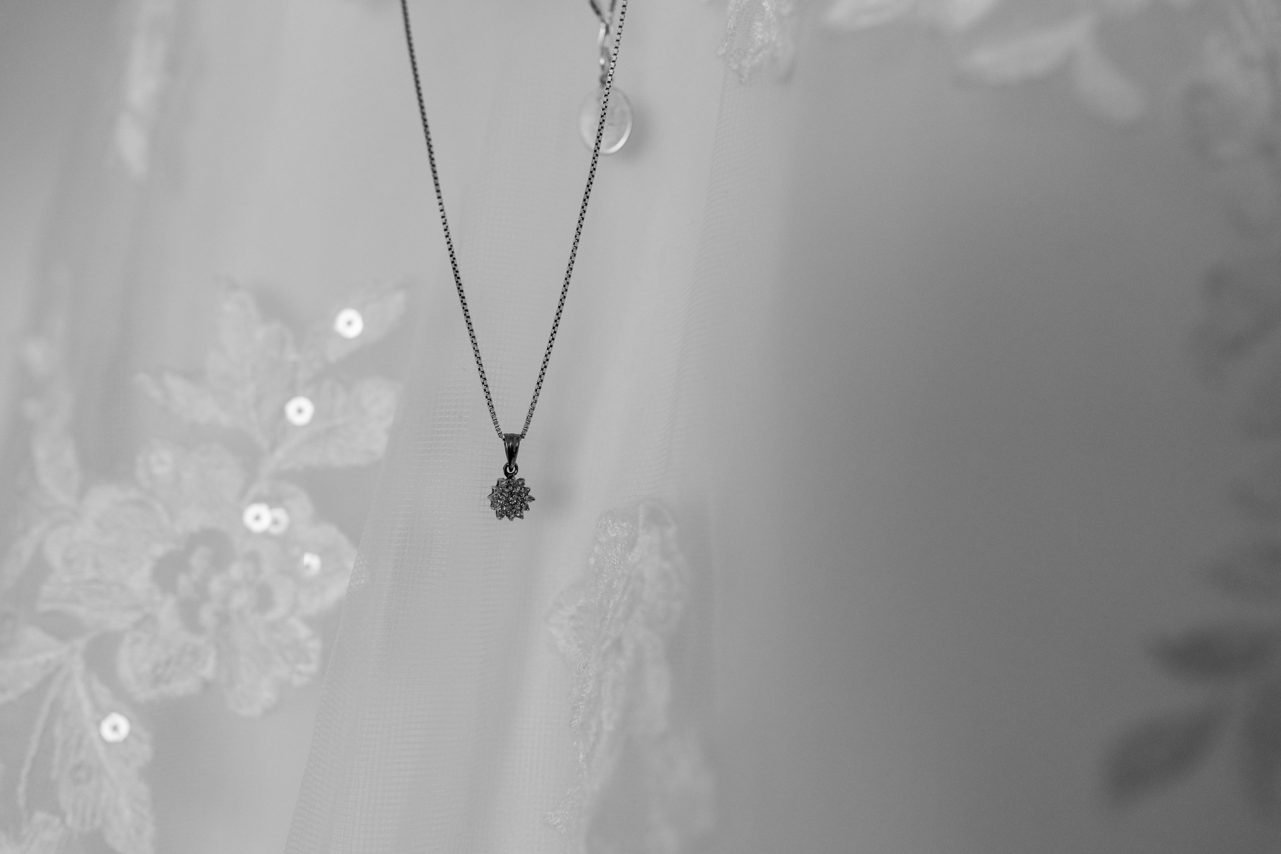Necklace against wedding dress. Grains Bar Hotel.