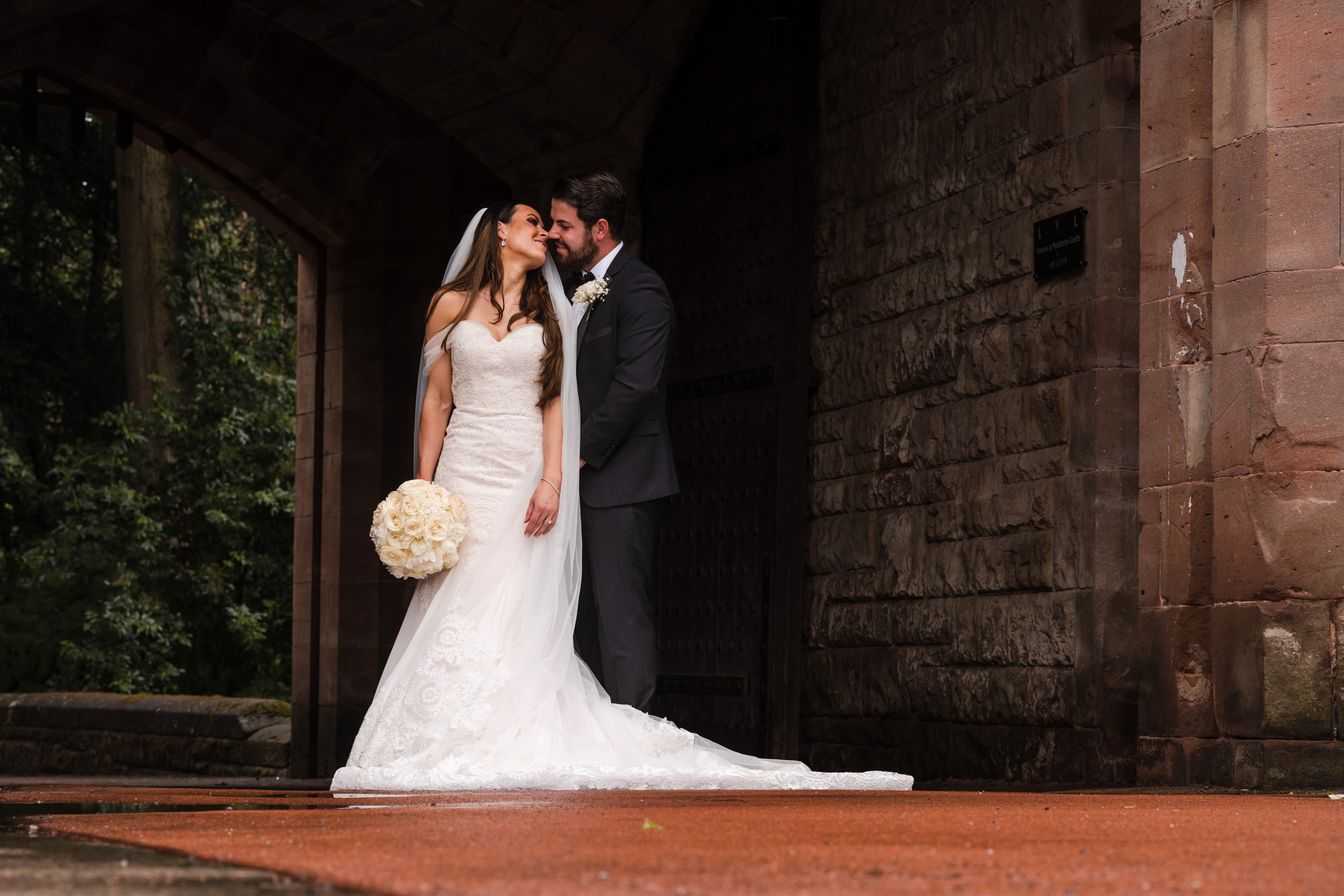 Couple looking at each other in the entry to Peckforton Castle