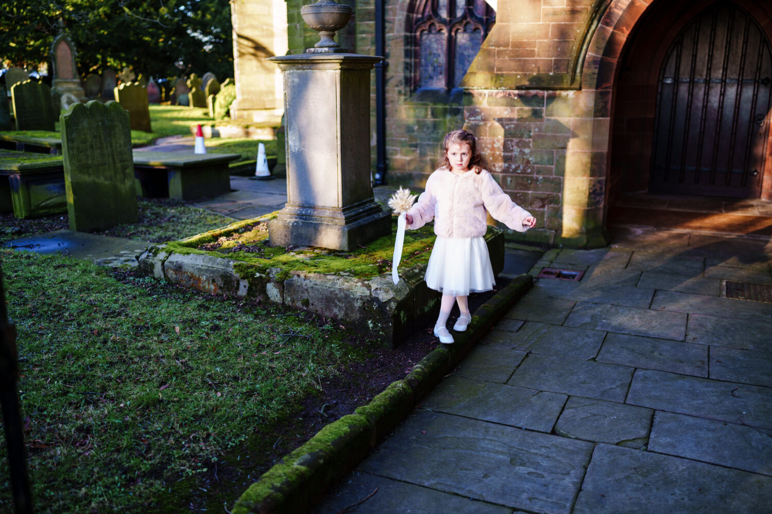 Flower girl playing outside All Saints Church