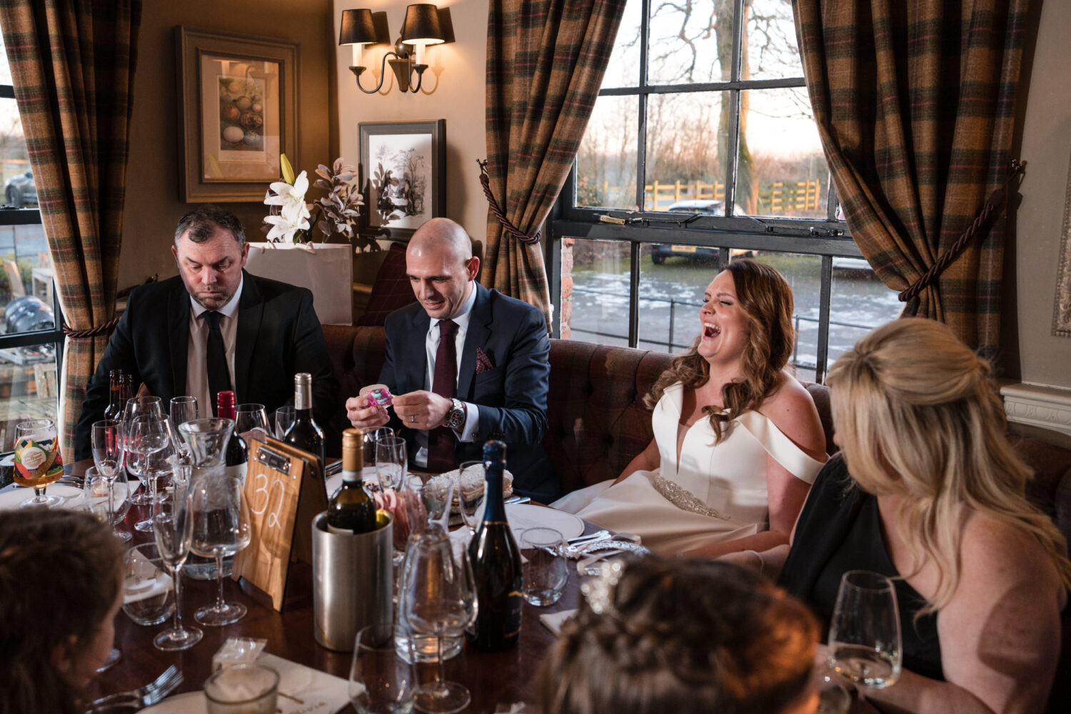 Bride and groom laughing at speeches at The Partridge Inn