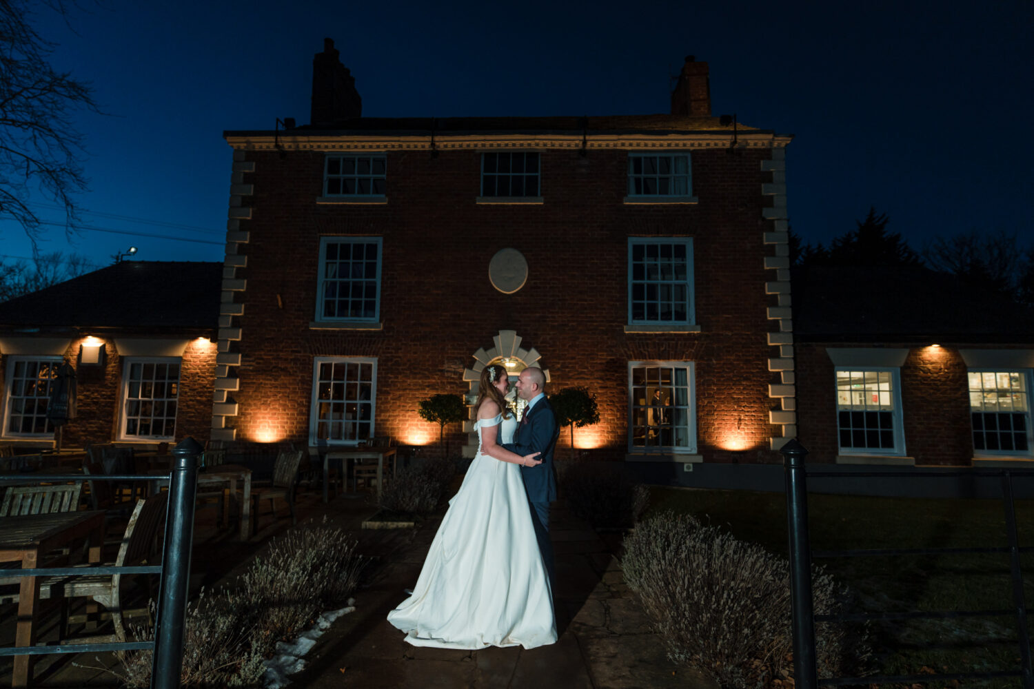 Flash lit portrait of the couple outside the Partridge