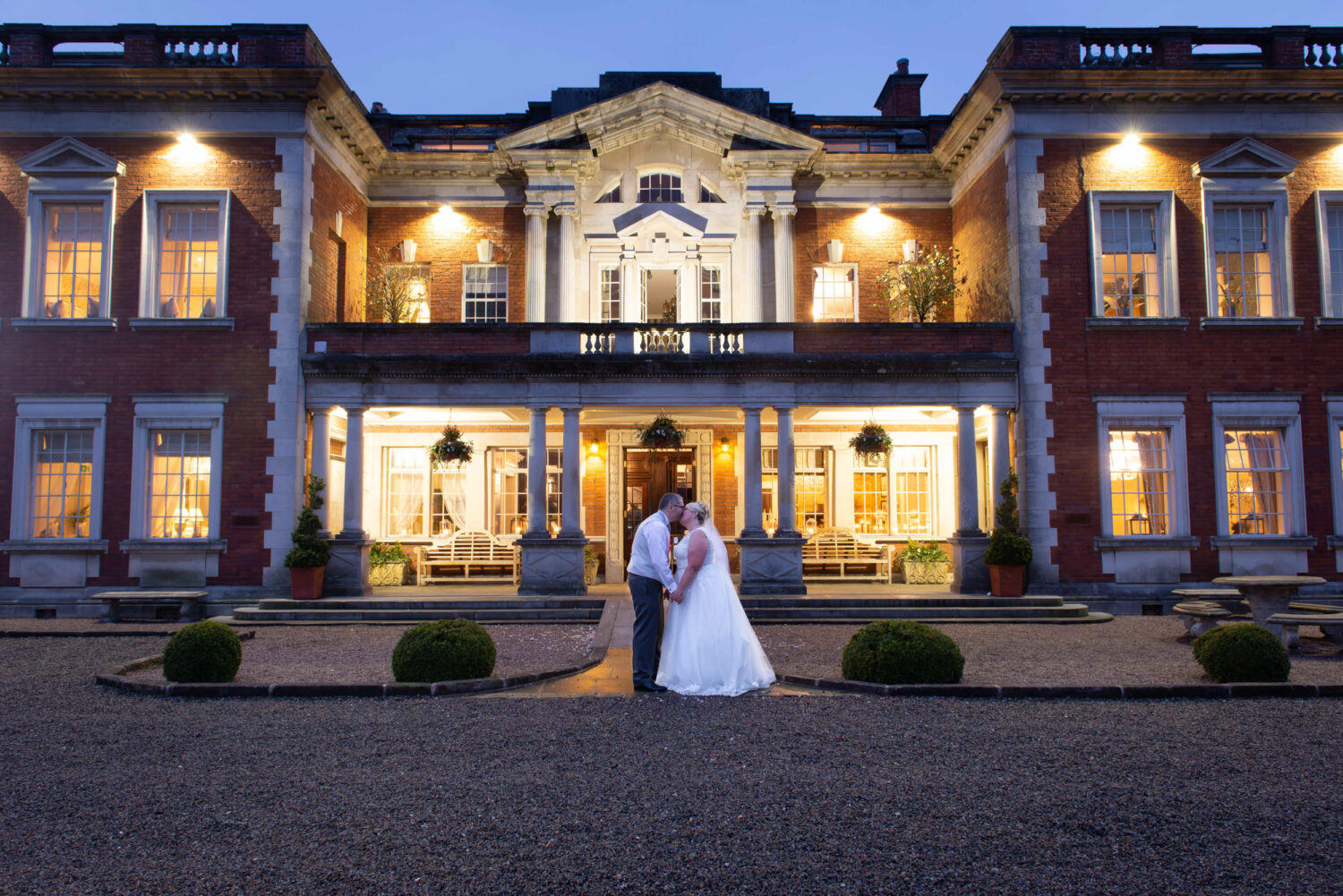 Bride and Groom Kissing outside Eaves Hall