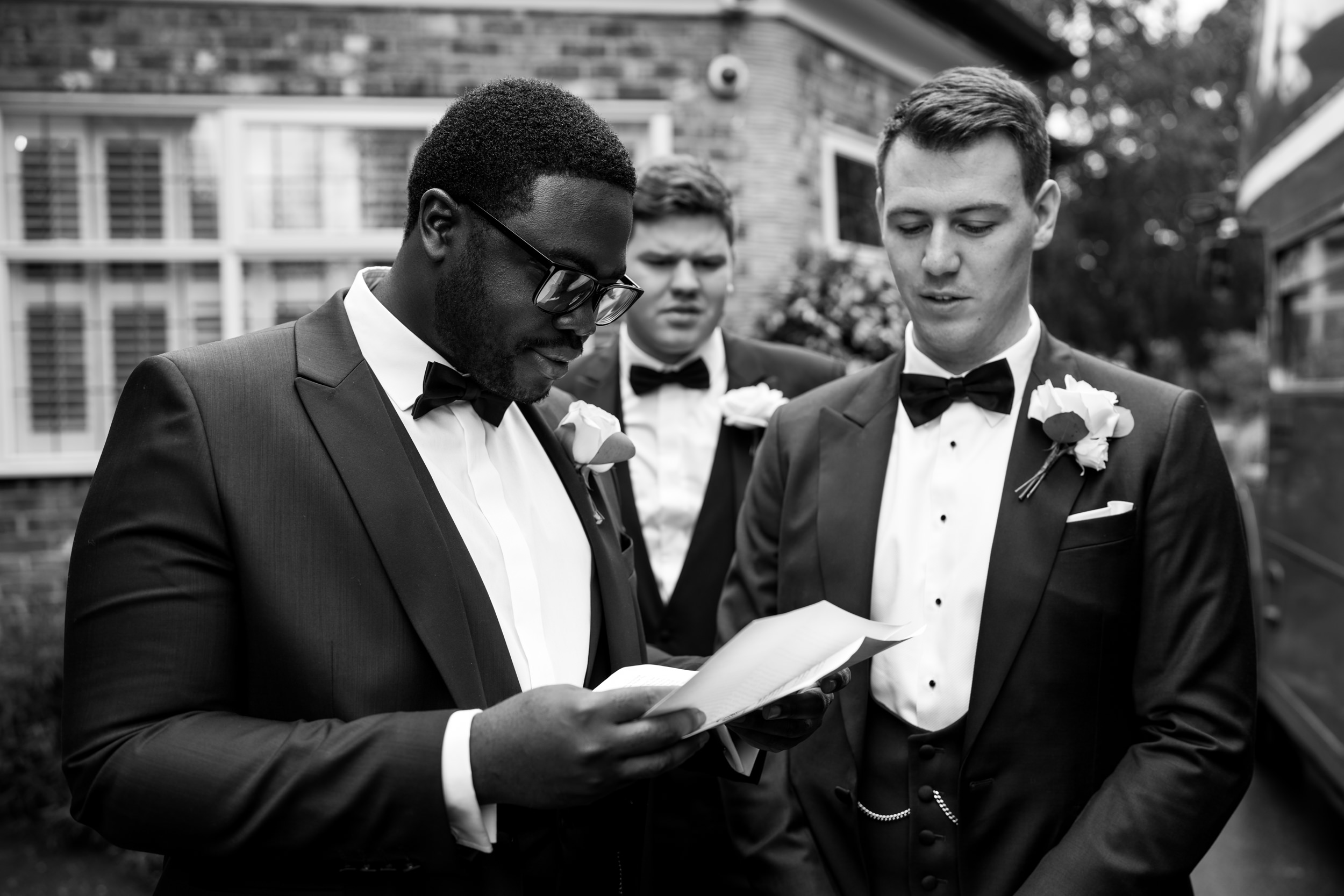 Best man reading over his speech outside the Stanneylands.