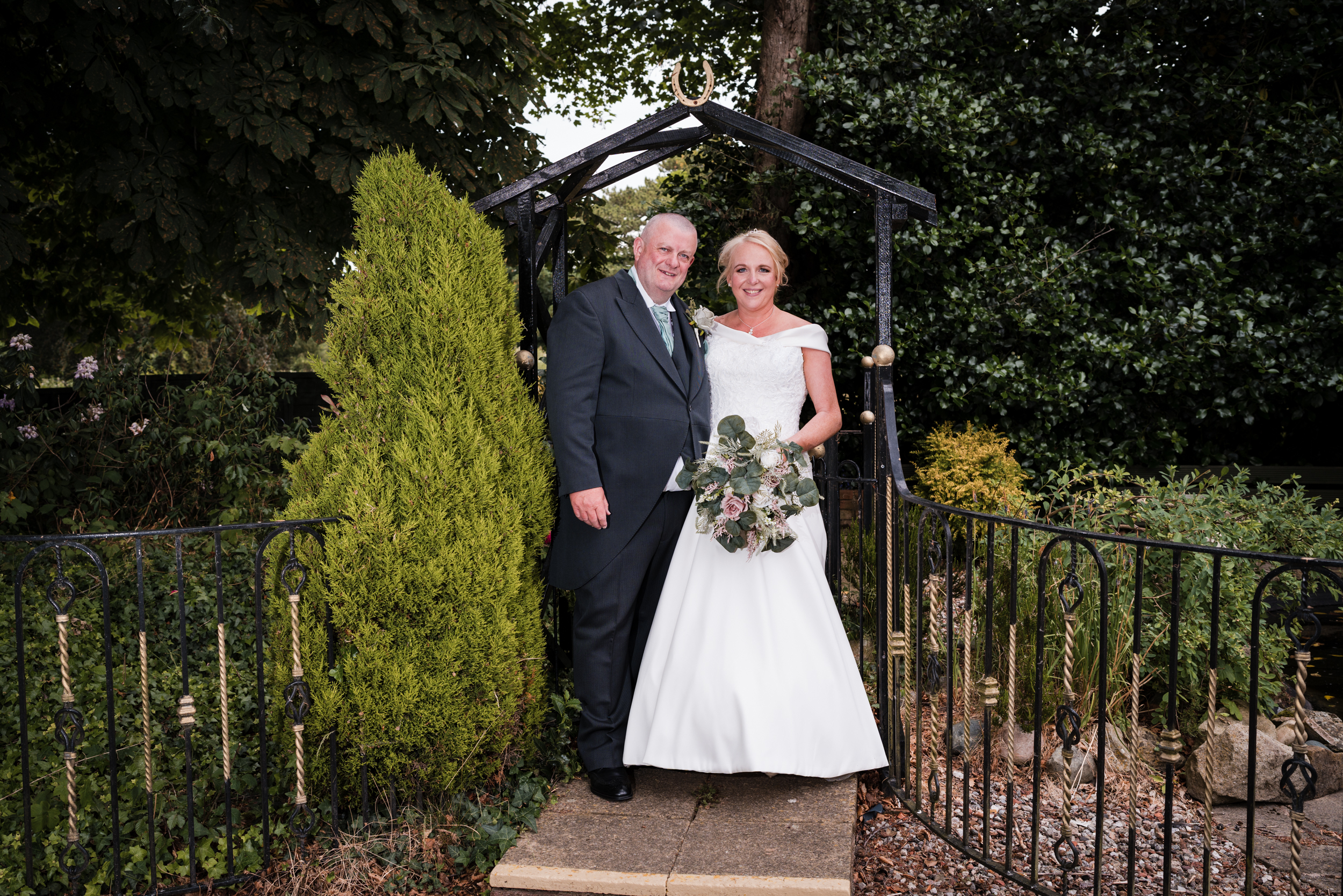 Bride and groom together in the gardens of Briars Hall