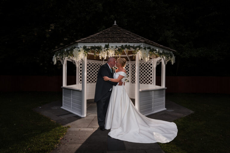 Bride and groom together in the gazebo at Briars Hall.