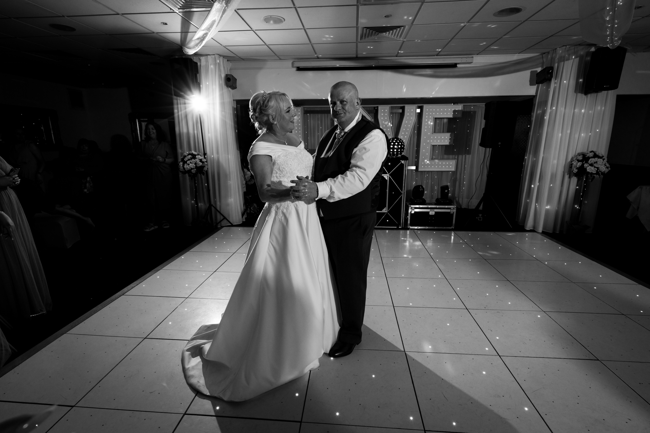 Black and white photo of the couple's first dance.