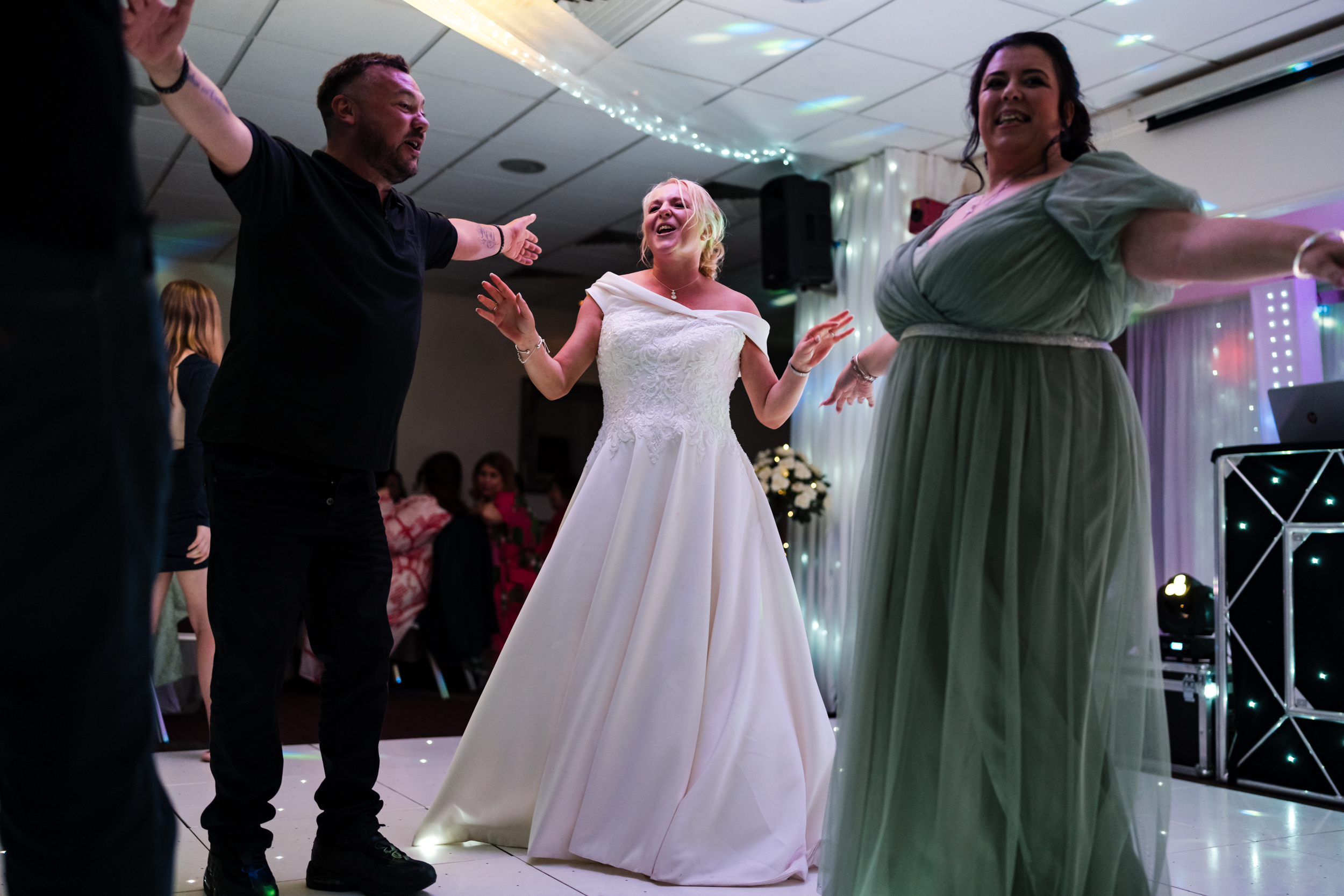 Bride surrounded by her guests dancing.