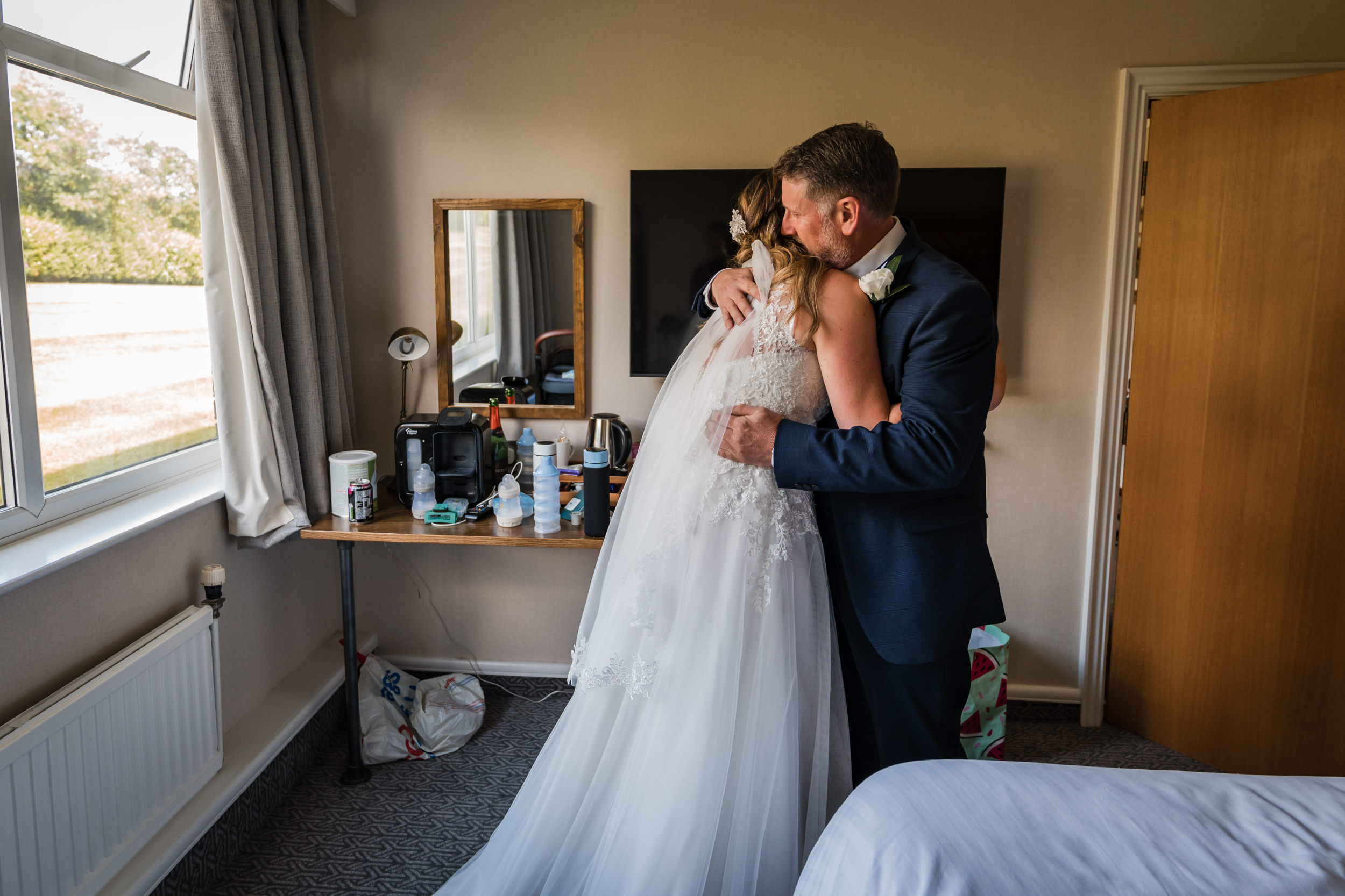 Bride and her father embracing at Cedar Court Hotel