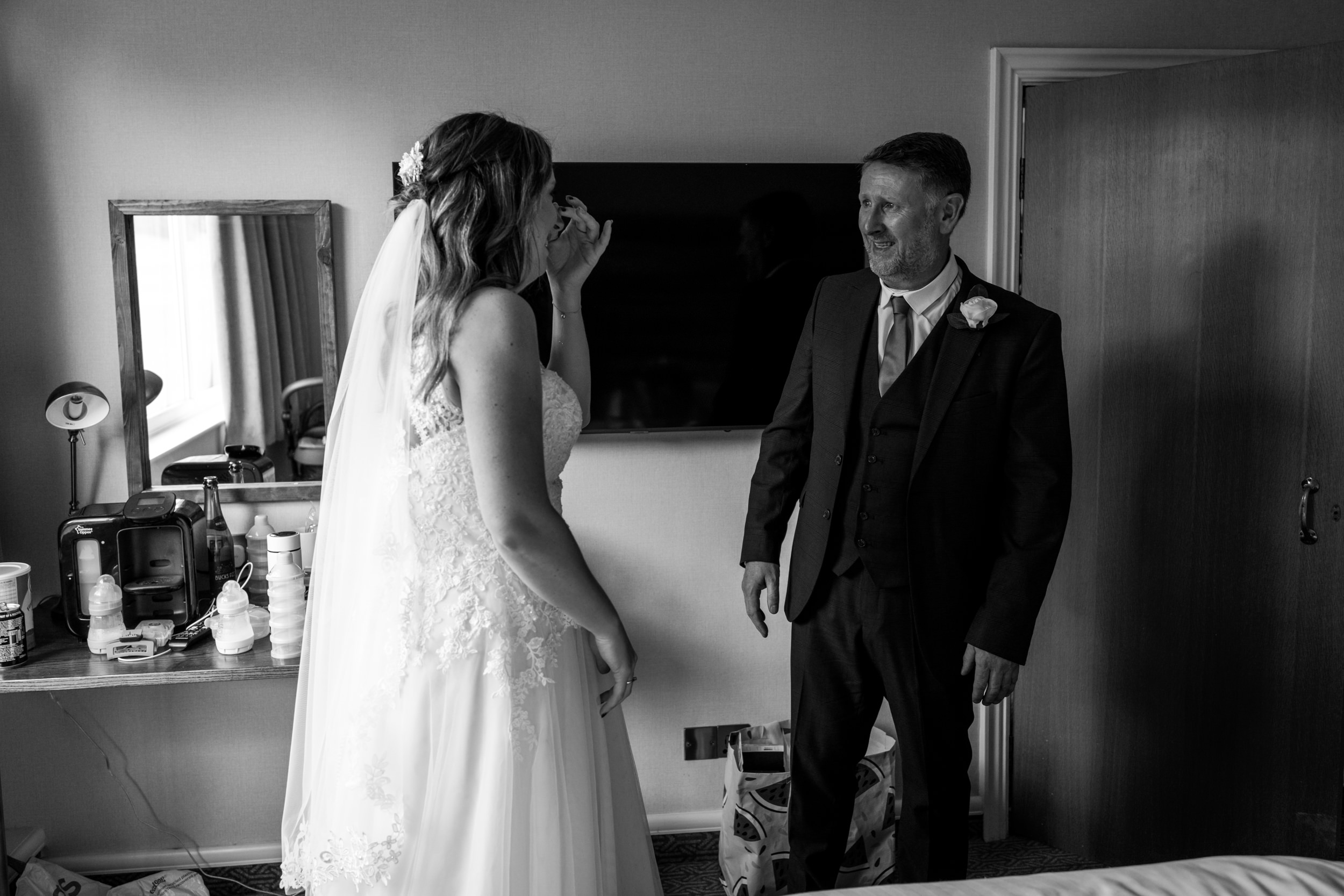 Bride and her father looking tearful at Cedar Court Hotel
