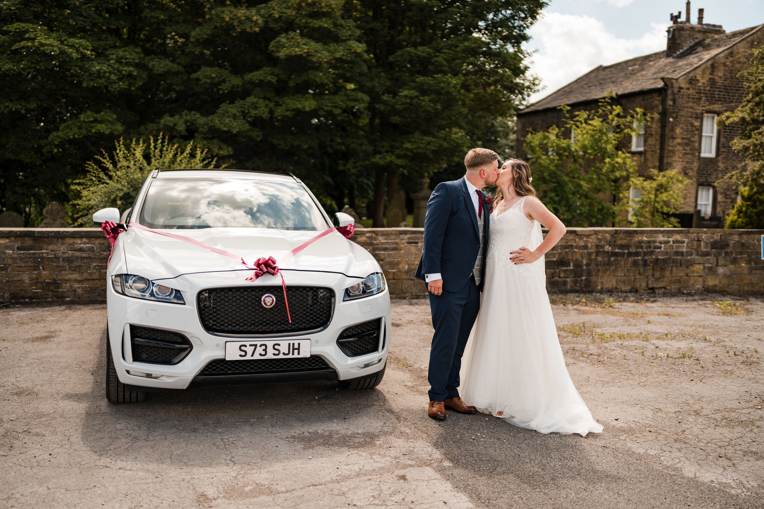 The couple with their wedding car. Cedar Court