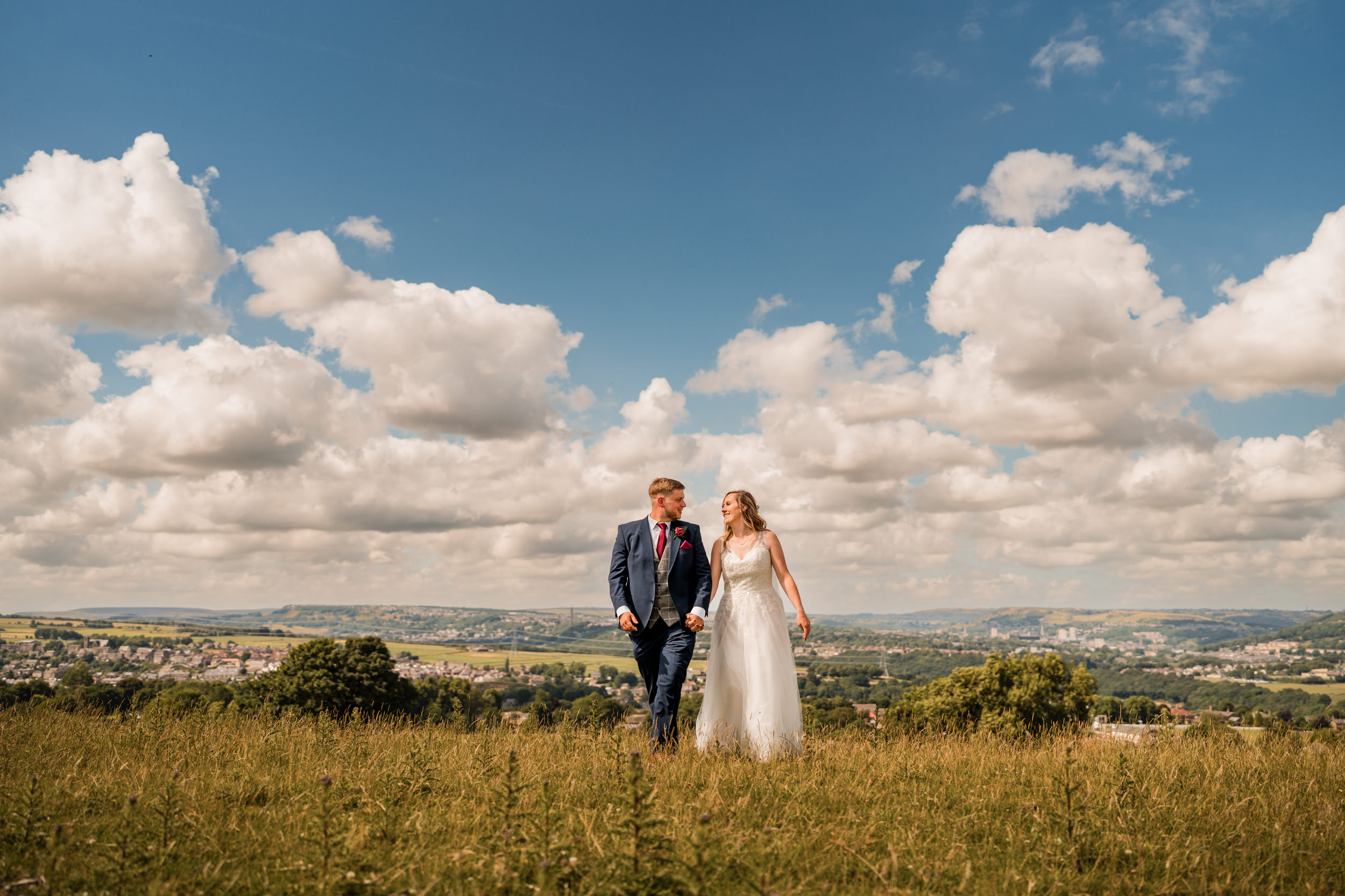 Couple walking through a field together