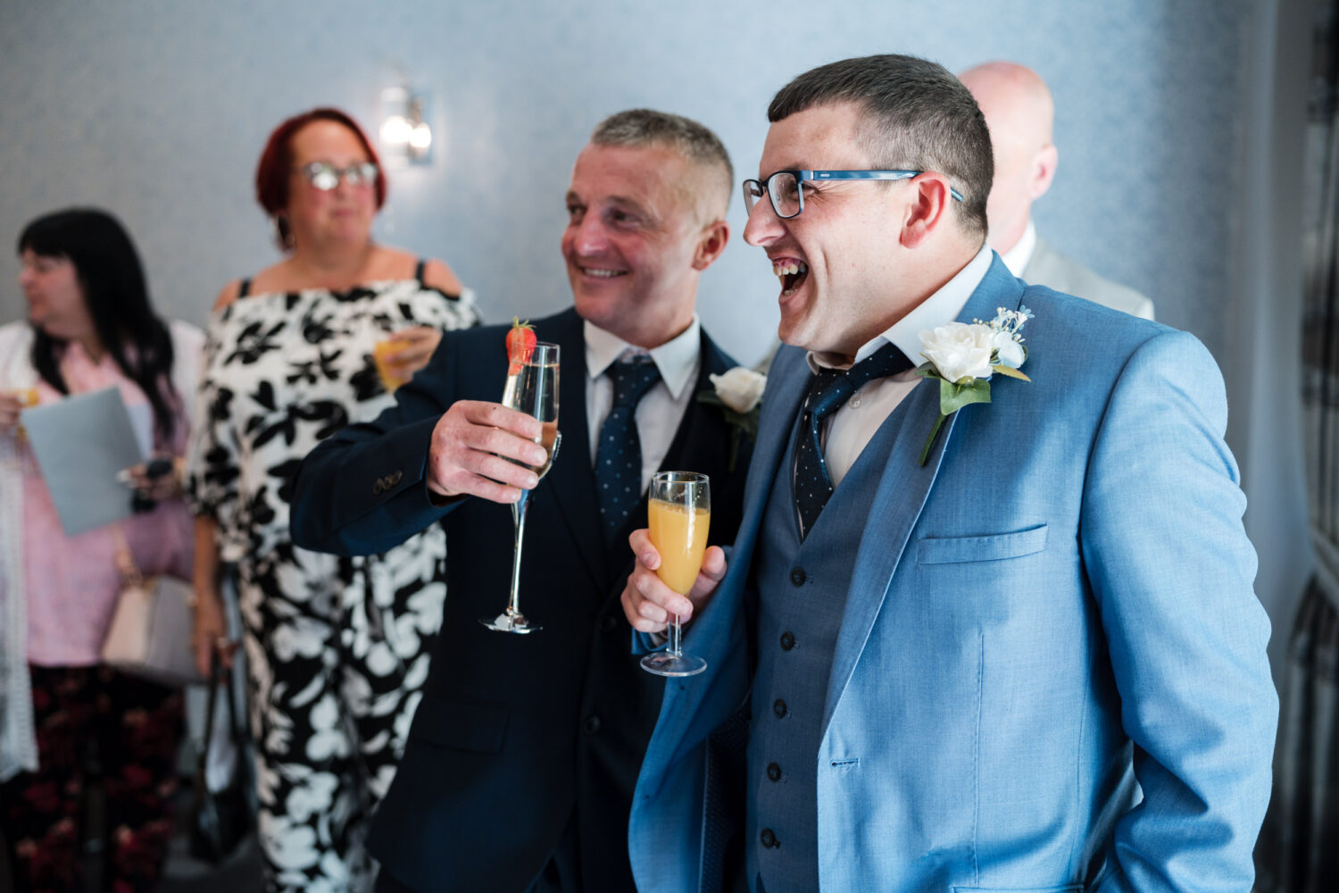 Groom and guests laughing at Norton Grange Hotel