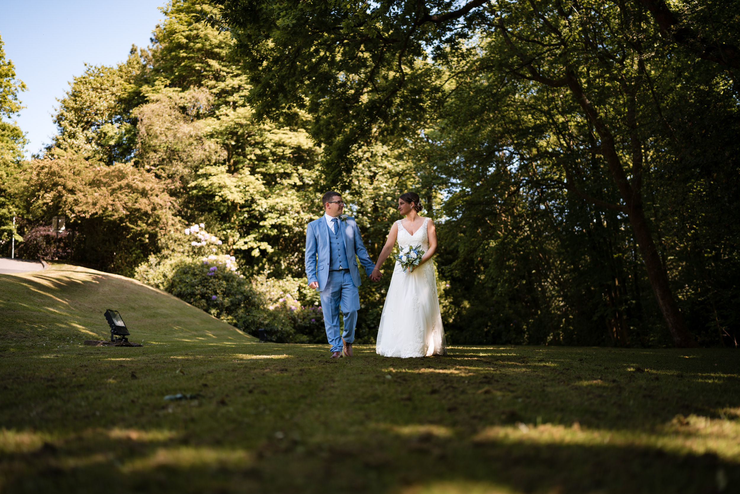 Melissa and Anthony walking together at their Spring Norton Grange Wedding