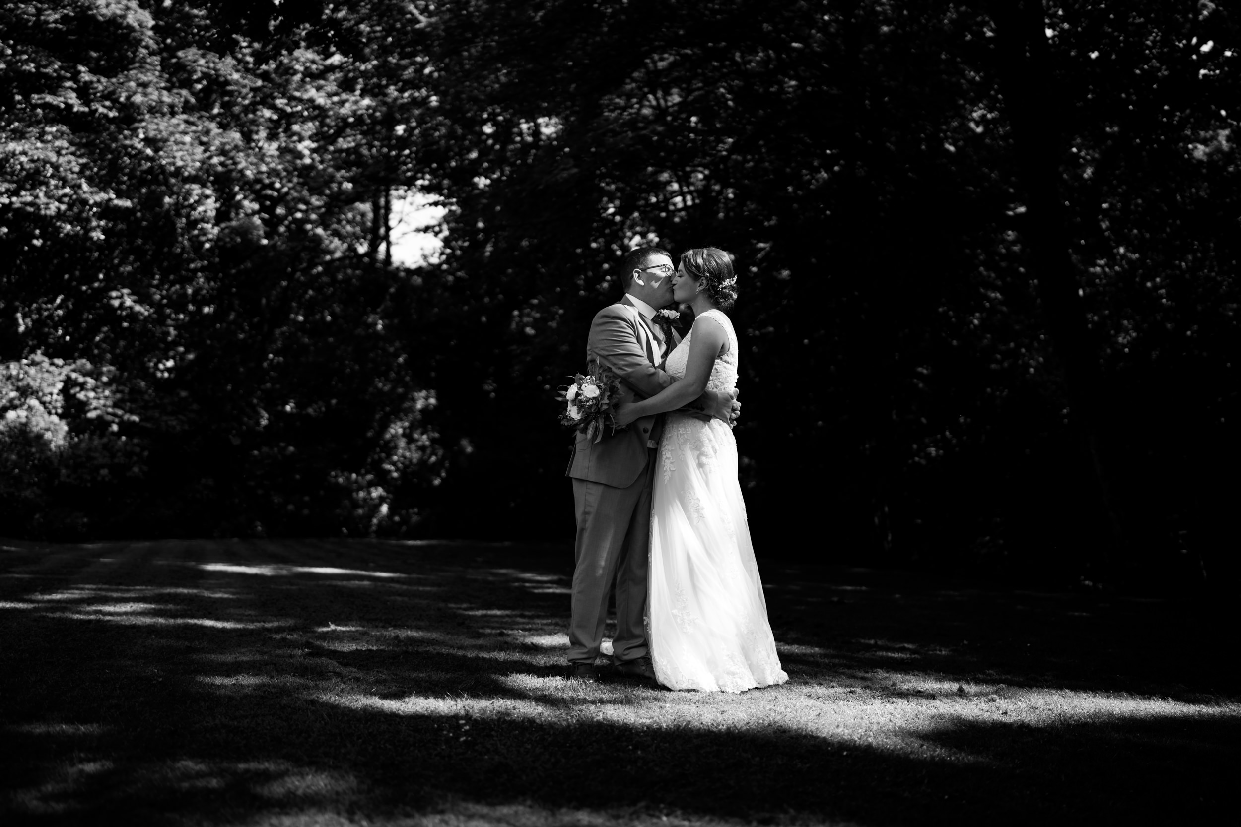 Black and white photo of the couple kissing at Norton Grange Hotel.