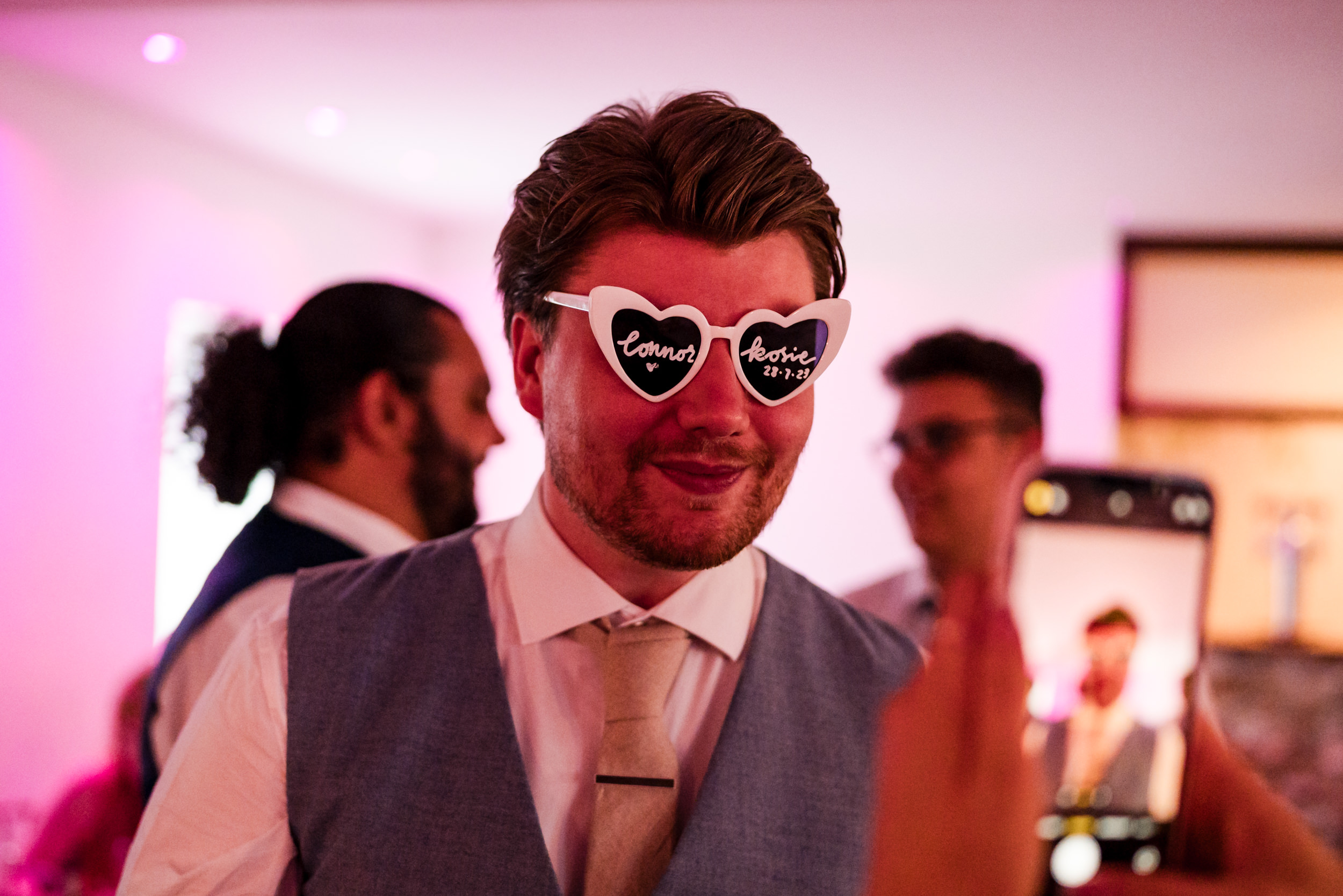 Groom wearing sunglasses at Grains Bar