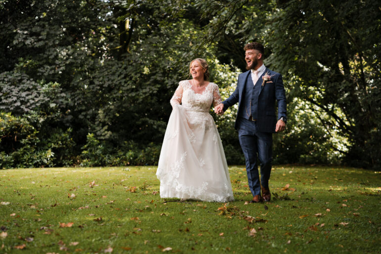 Bride and groom walking together at Norton Grange