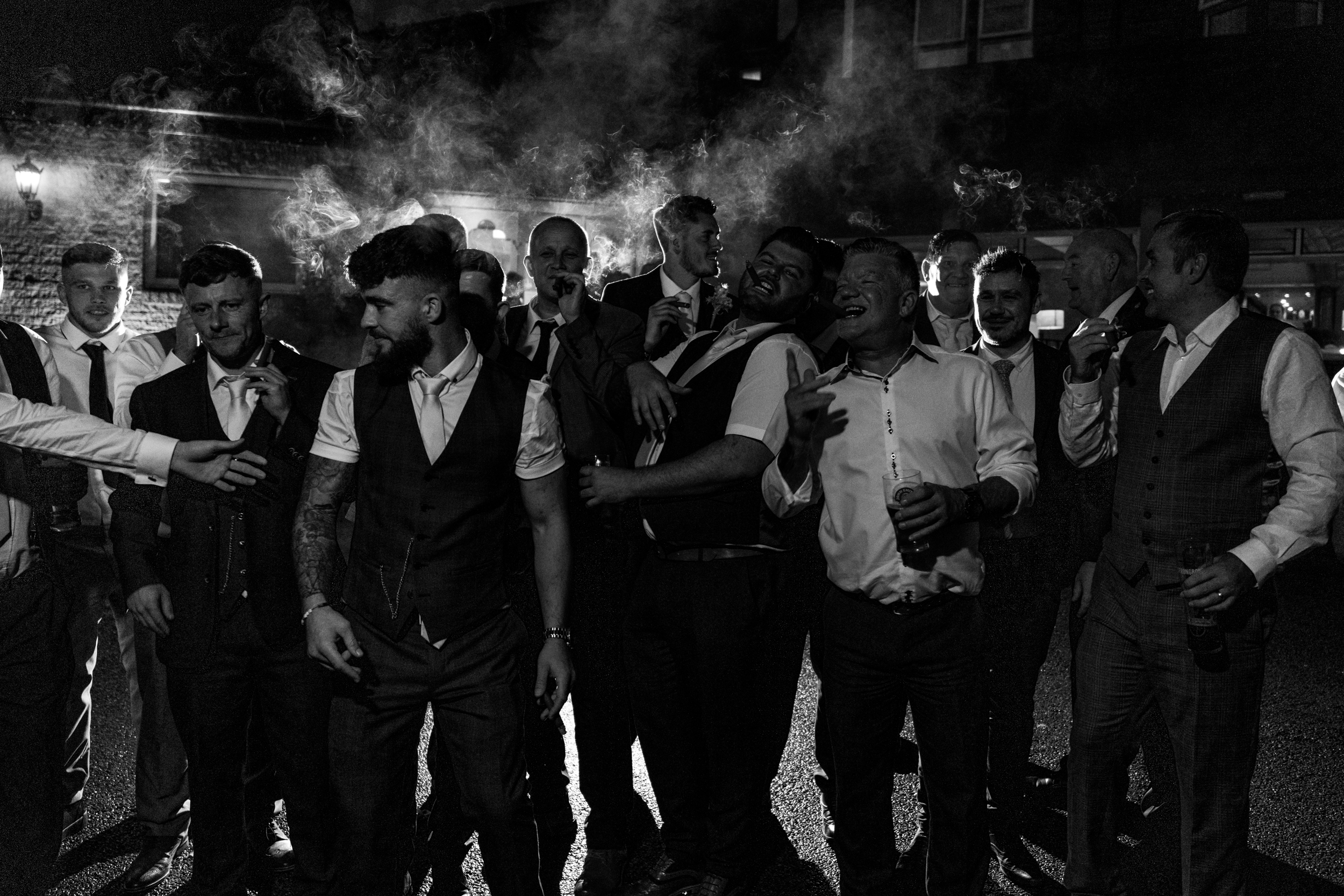 Groom and groomsmen smoking cigars at Norton Grange