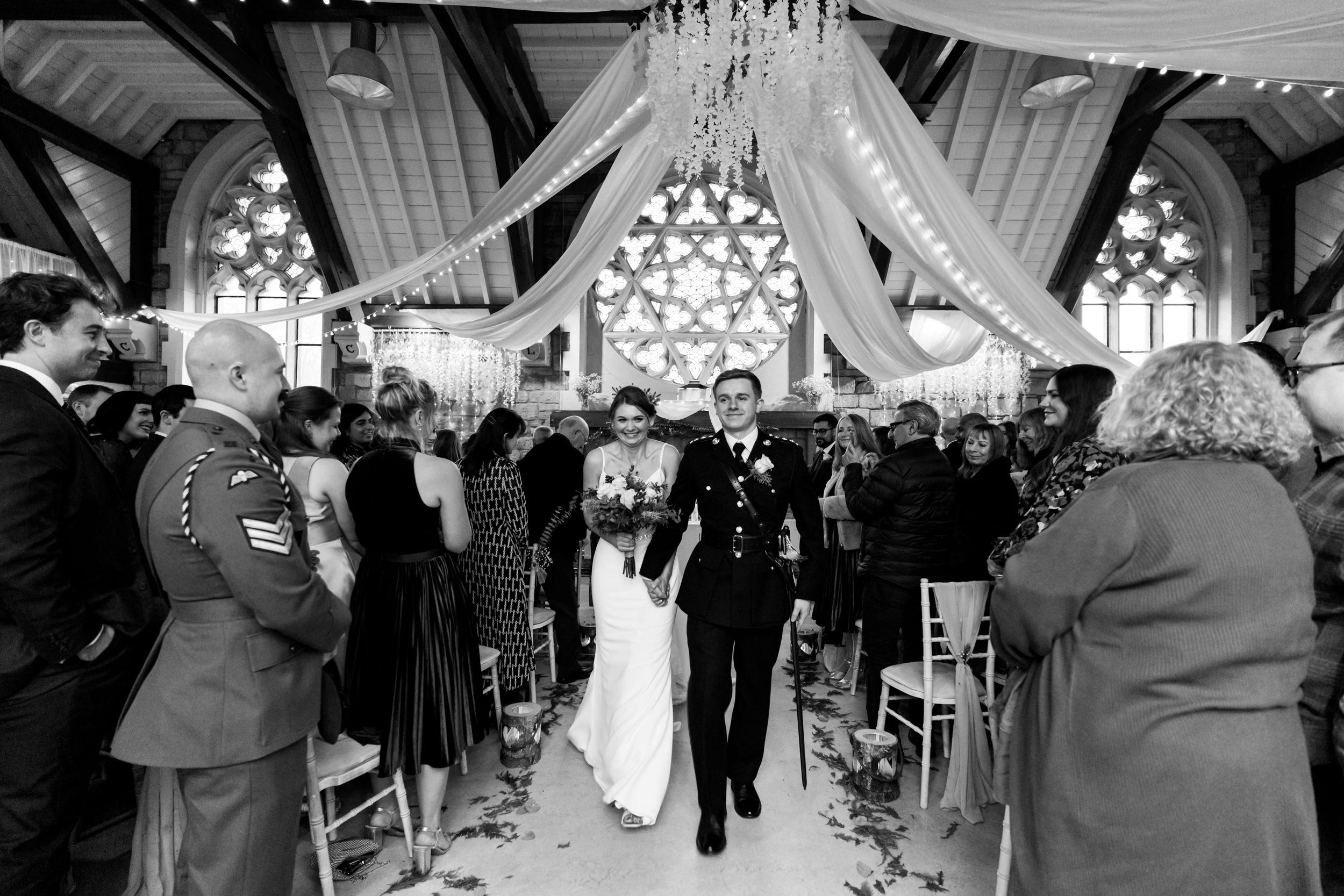 Bride and groom walking out together. Fielden Hall.