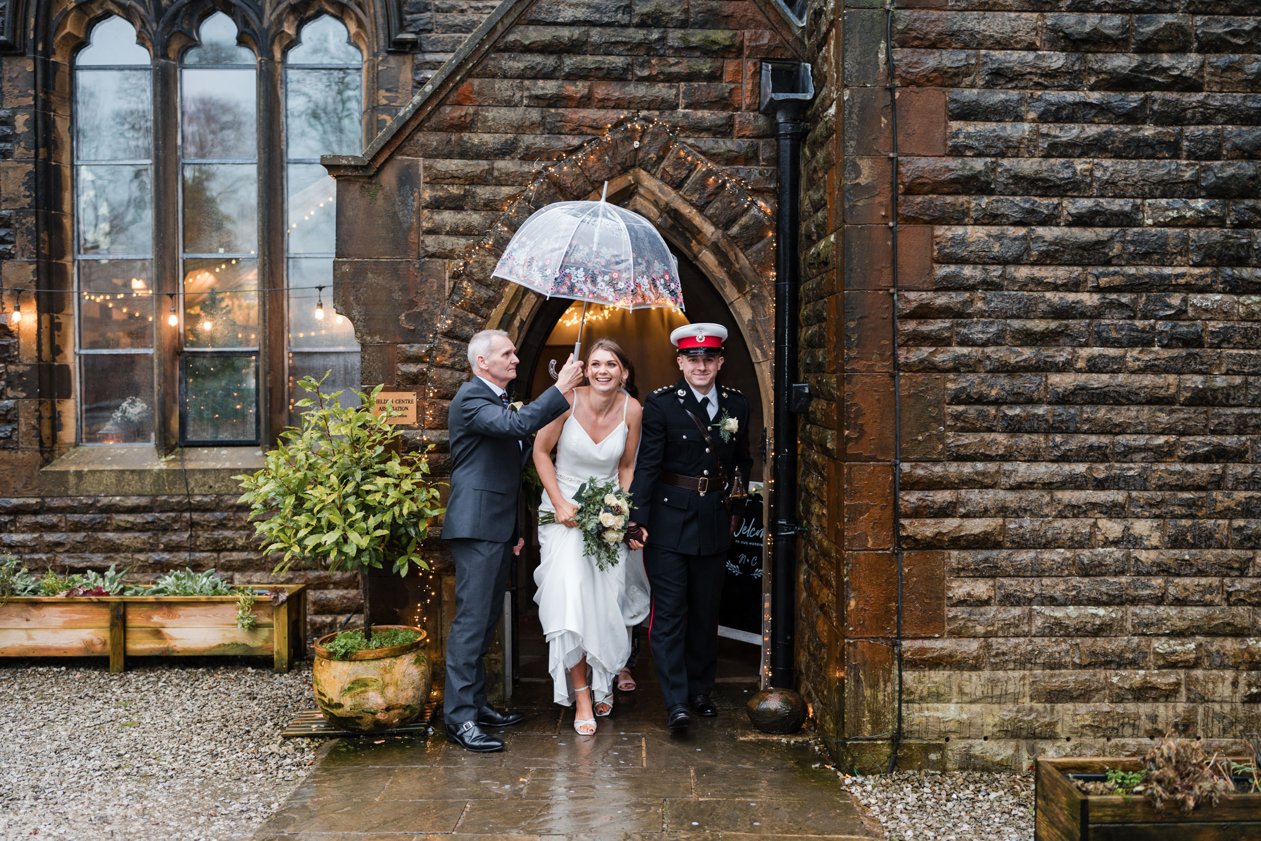 Couple walking to the confetti. Fielden Hall