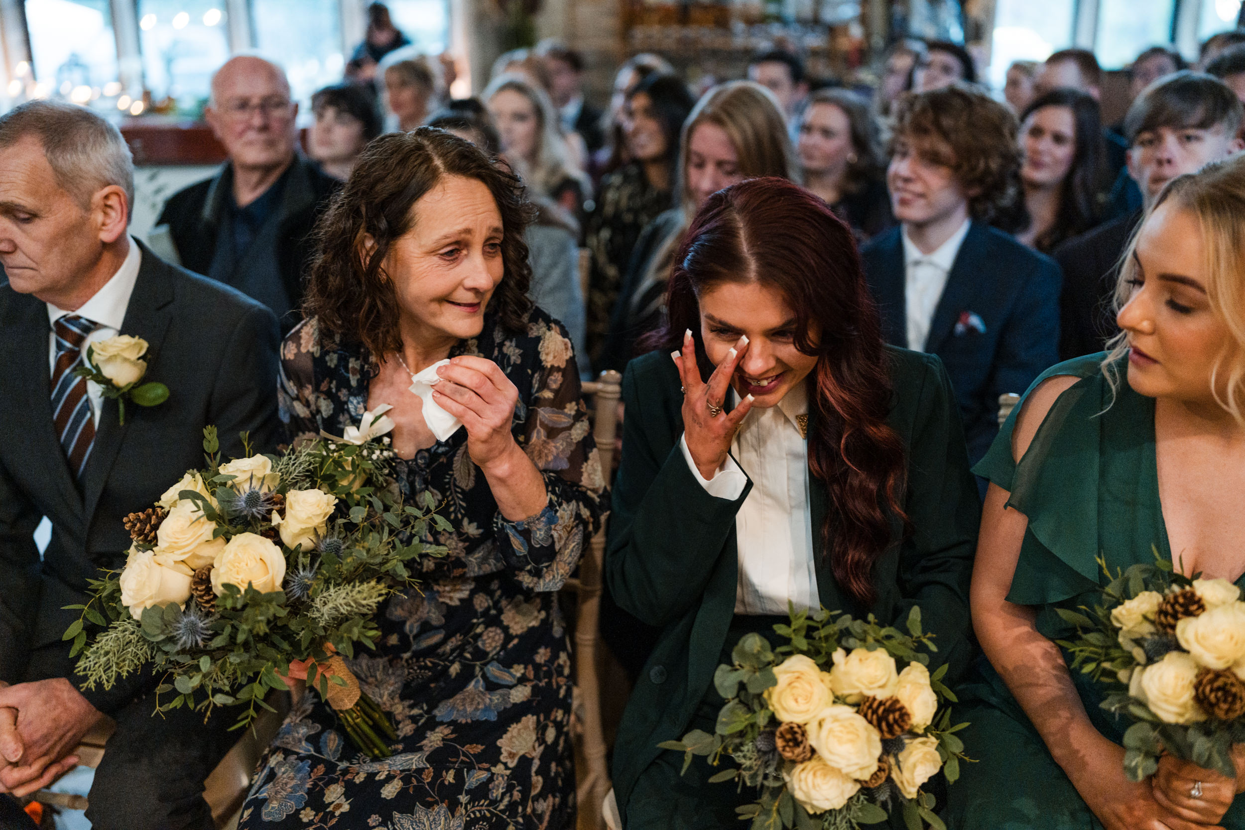 Bridesmaid wiping away tears of happiness. Fielden Hall.