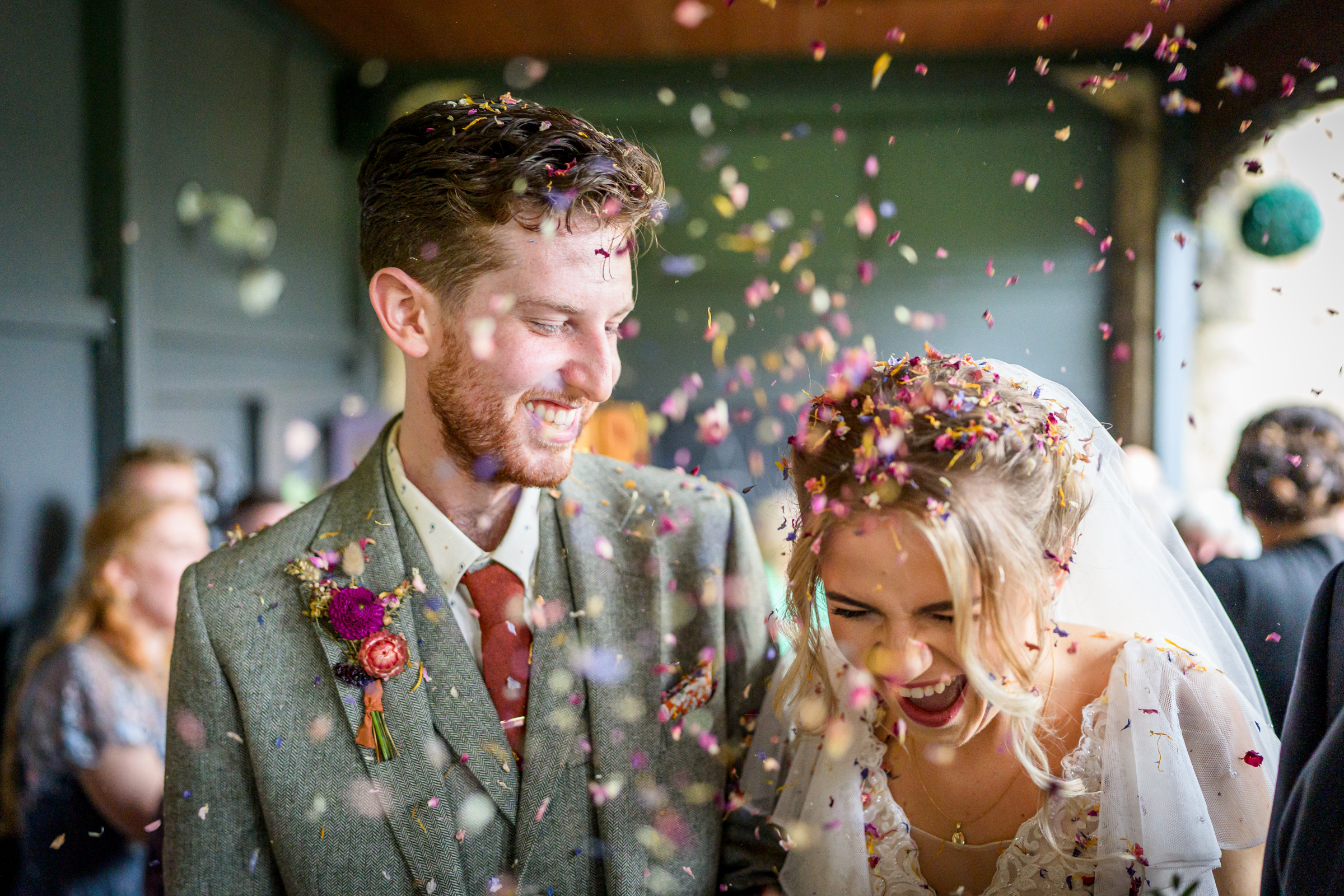 Bride and groom being showered by confetti at the Old Barn Esholt