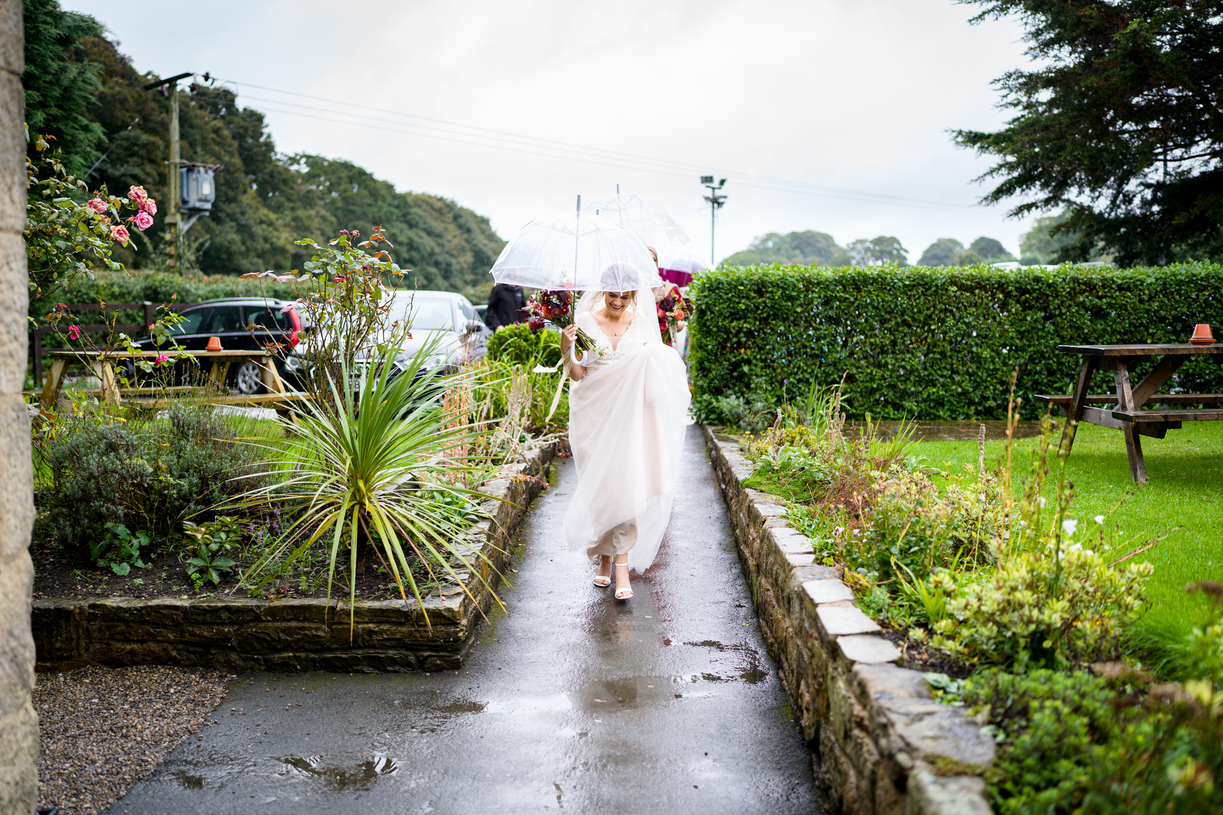 Bride leading the bridesmaids into the Old Barn, Esholt