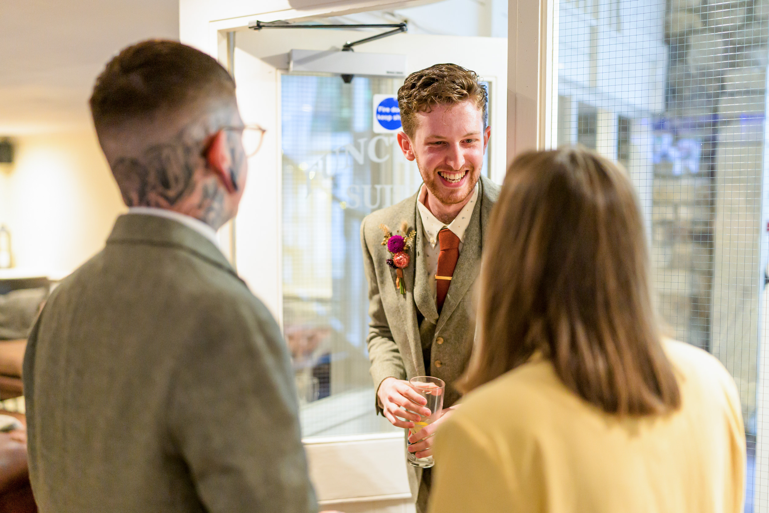 Groom talking to his guests at the Old Barn, Esholt