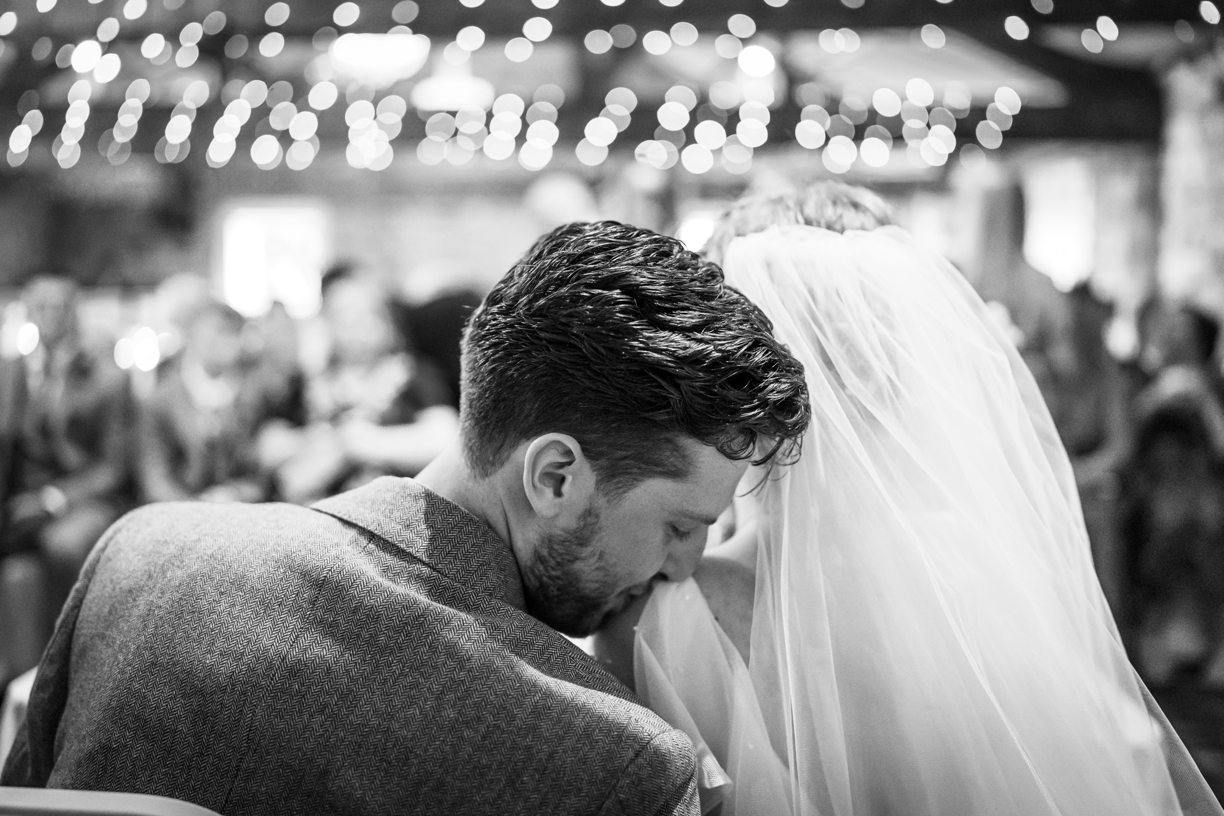 Groom kissing the bride's shoulder