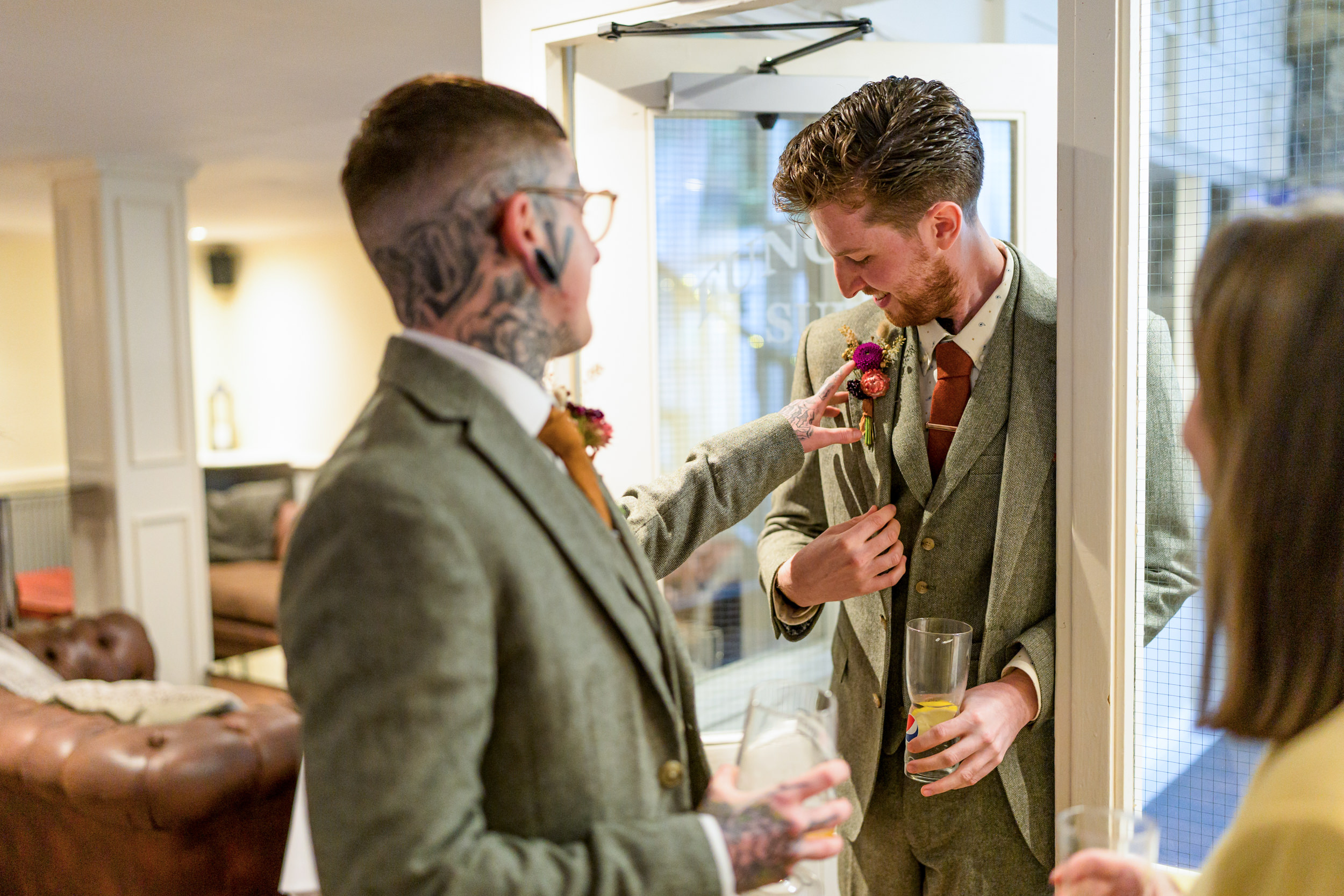 Groom having his buttonhole adjusted at the Old Barn, Esholt