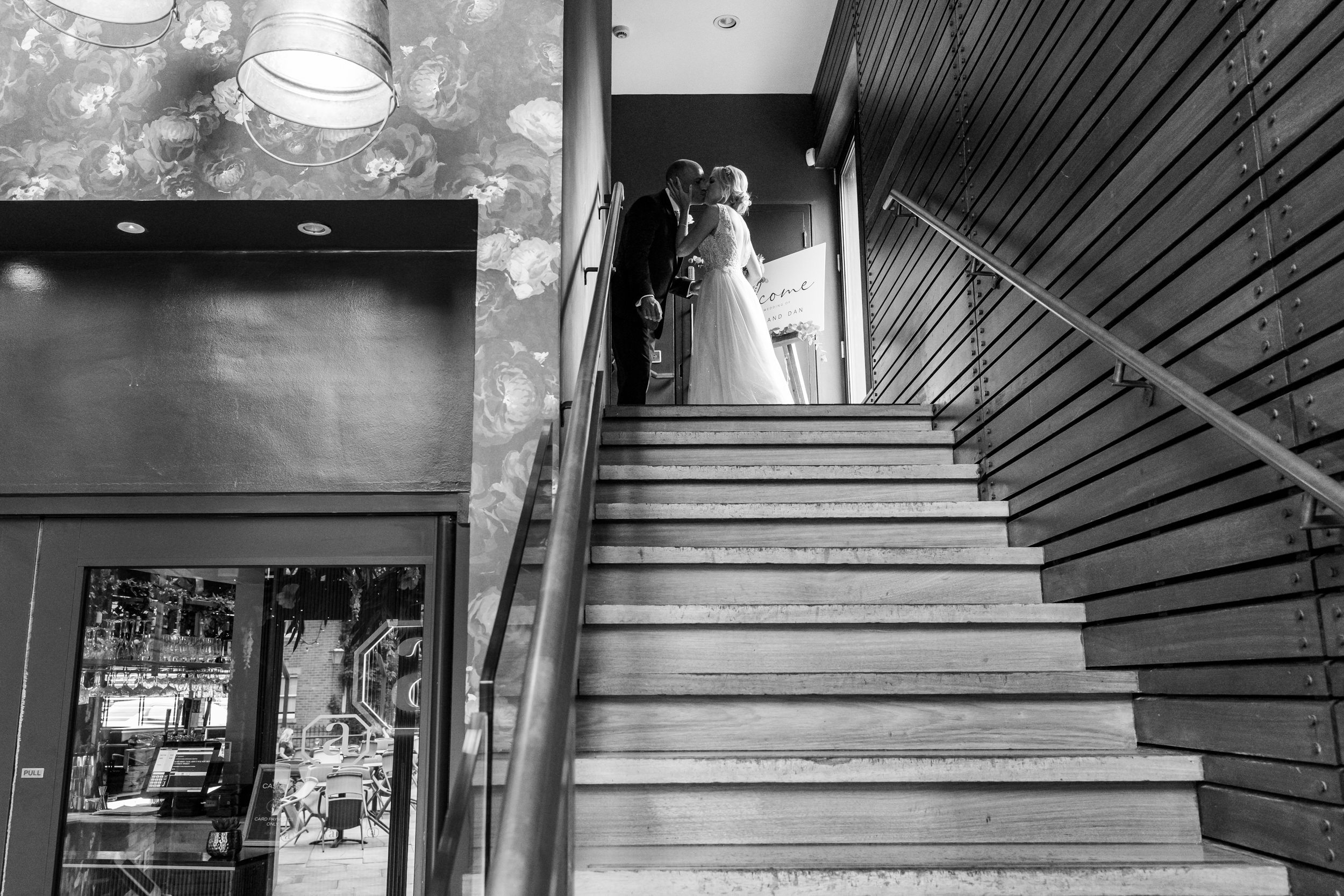 Bride and groom at the top of the stairs having a private moment
