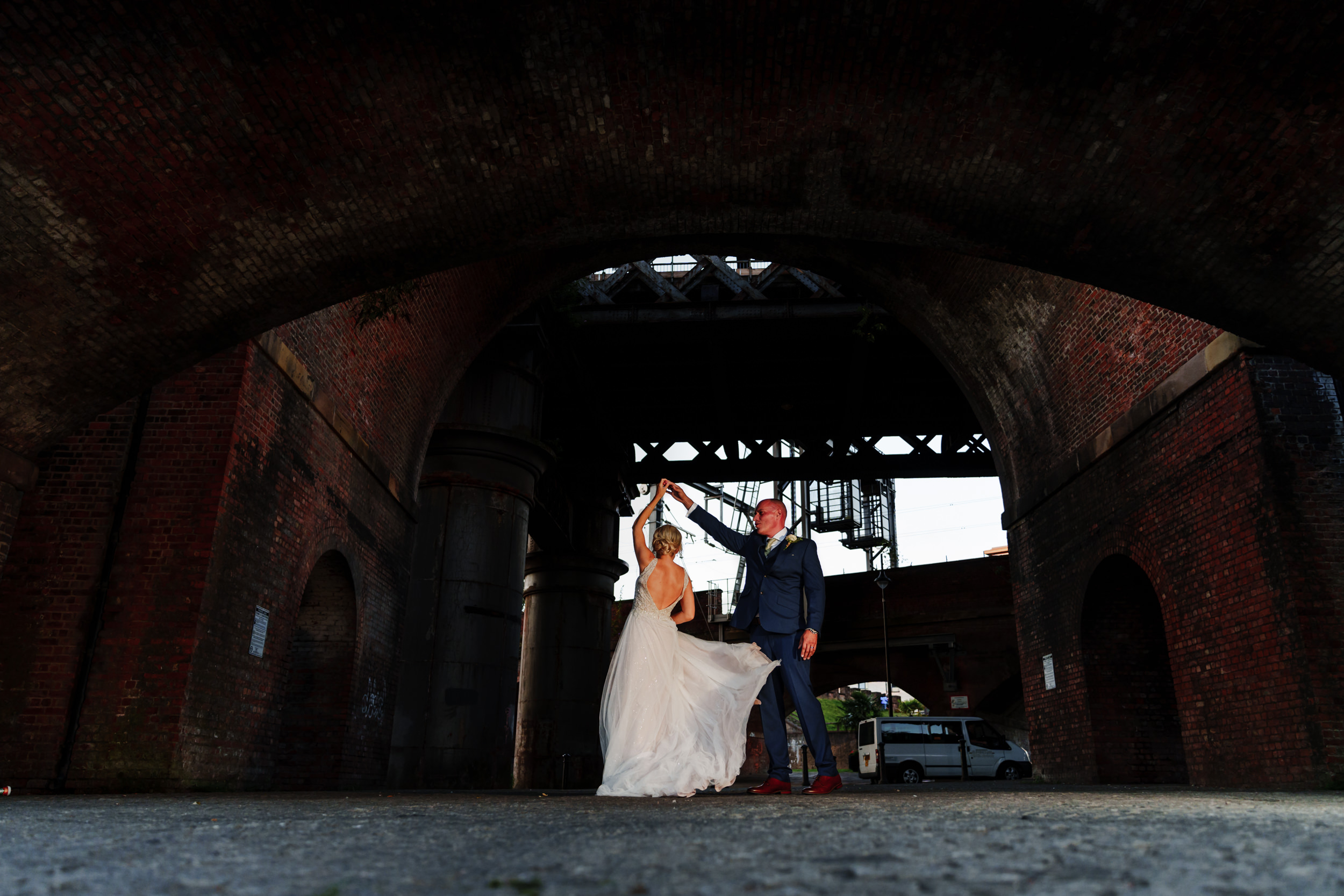 Bride and groom dancing under the arches near the Castlefield Rooms