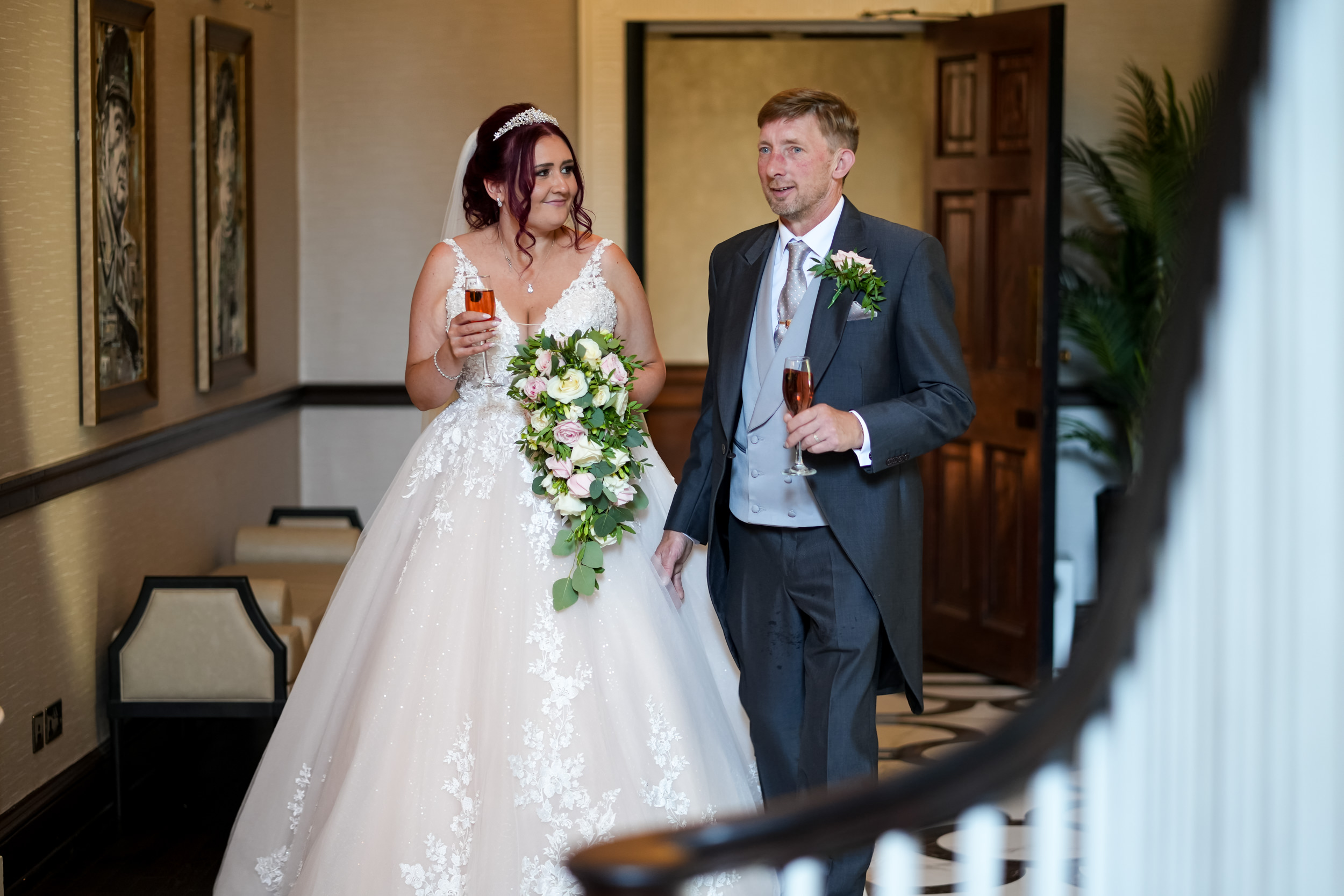 Bride and groom walking to their wedding breakfast