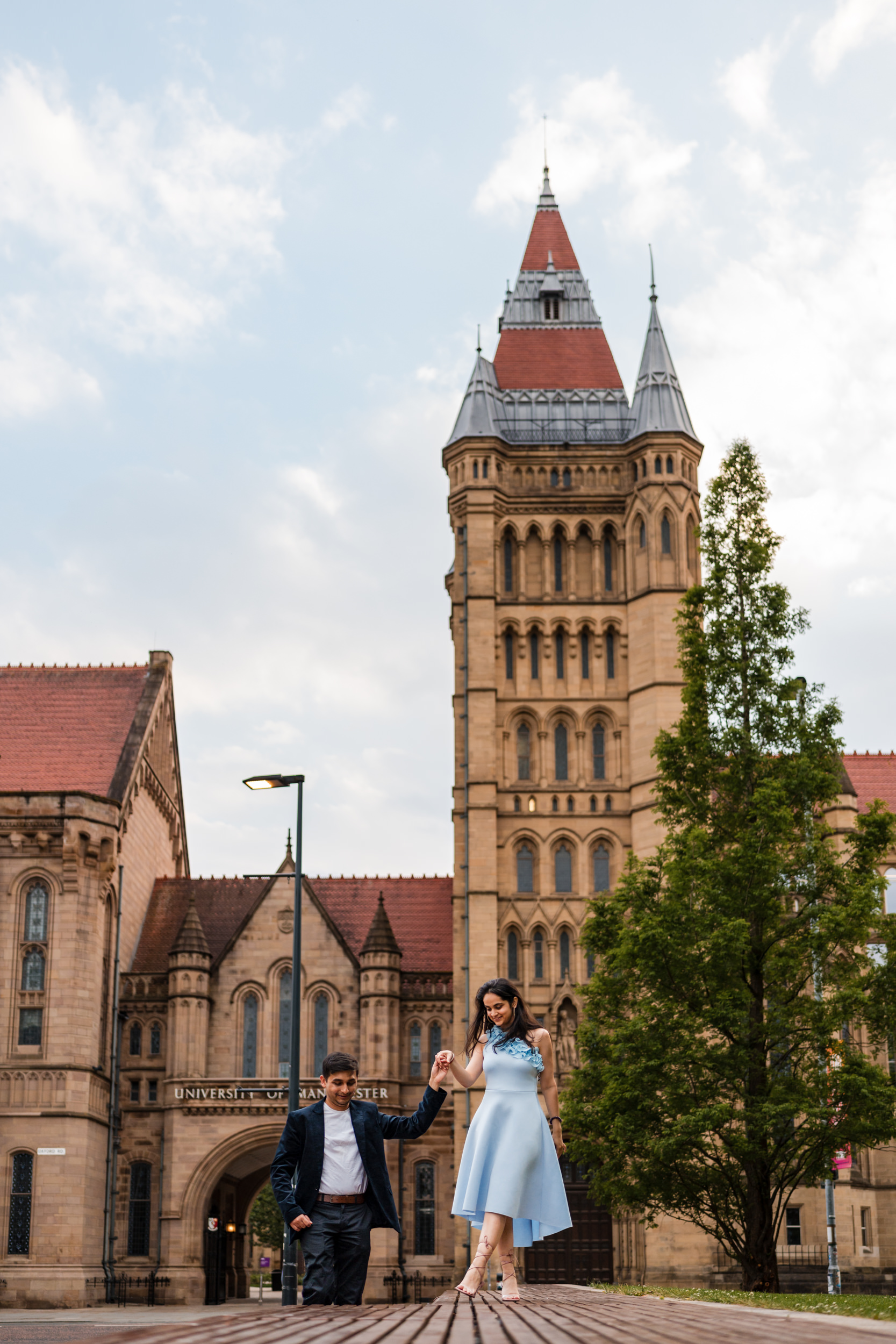 Couple walking outside the University of Manchester.