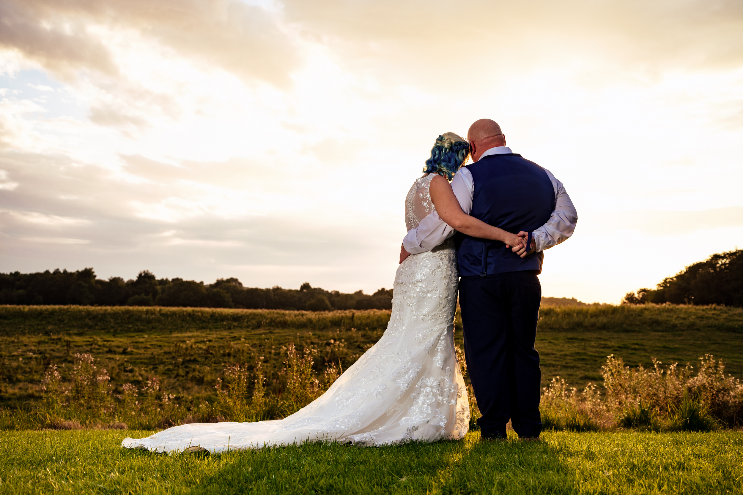 The bride and groom looking out over the fields at Norton Grange