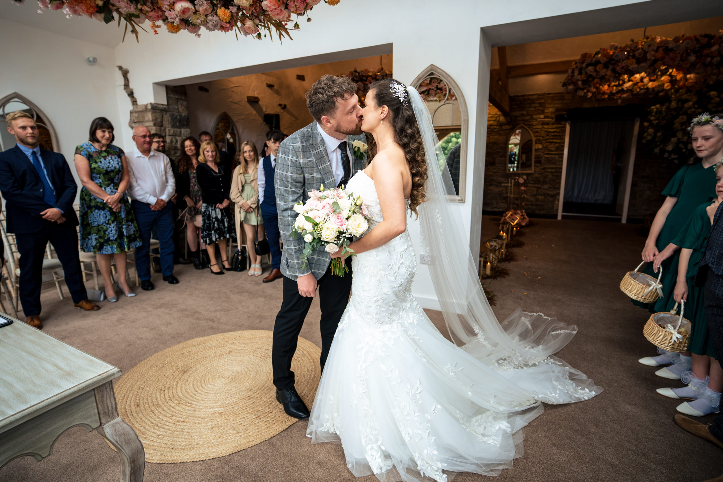 Bride and groom having a quick kiss before their wedding ceremony