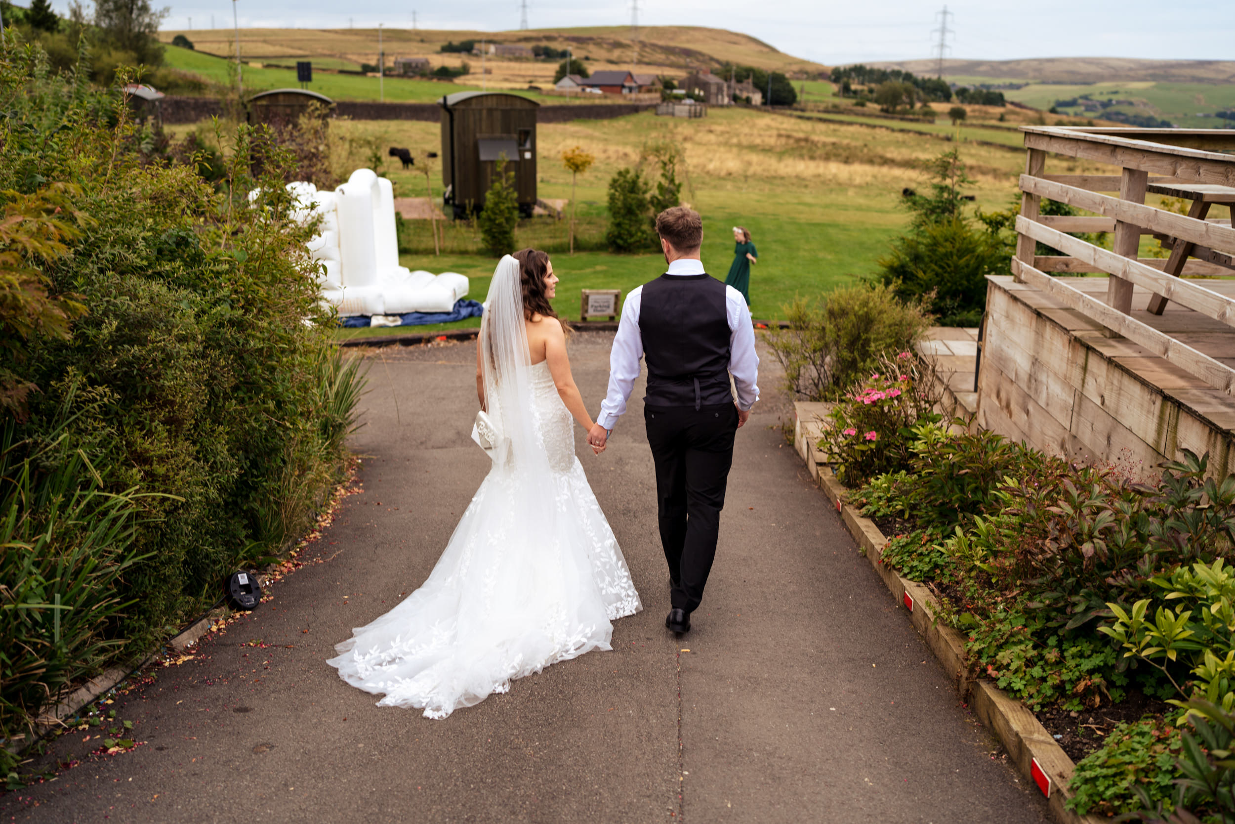 Couple walking down to the bouncy castle