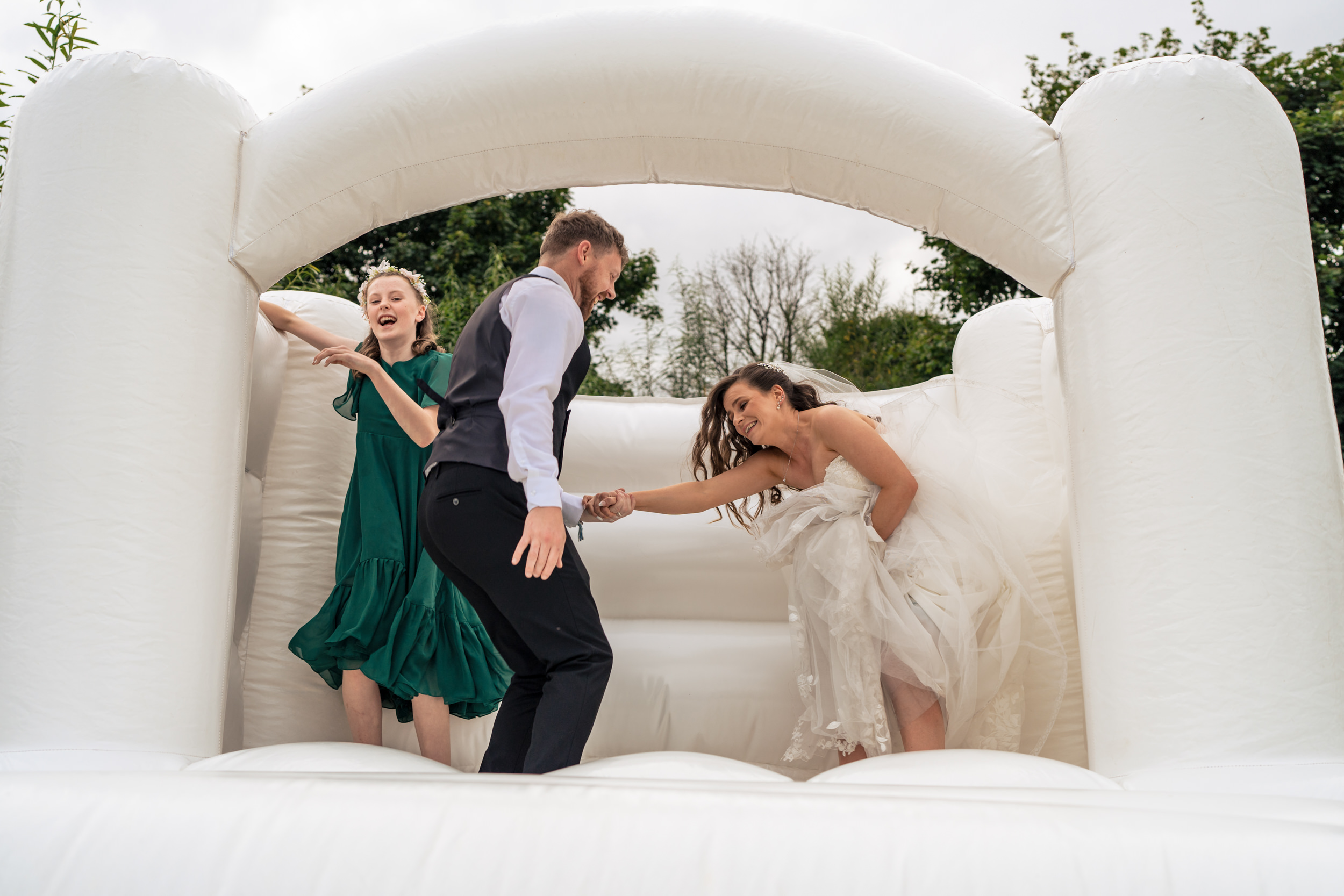 Bride and groom on the bouncy castle