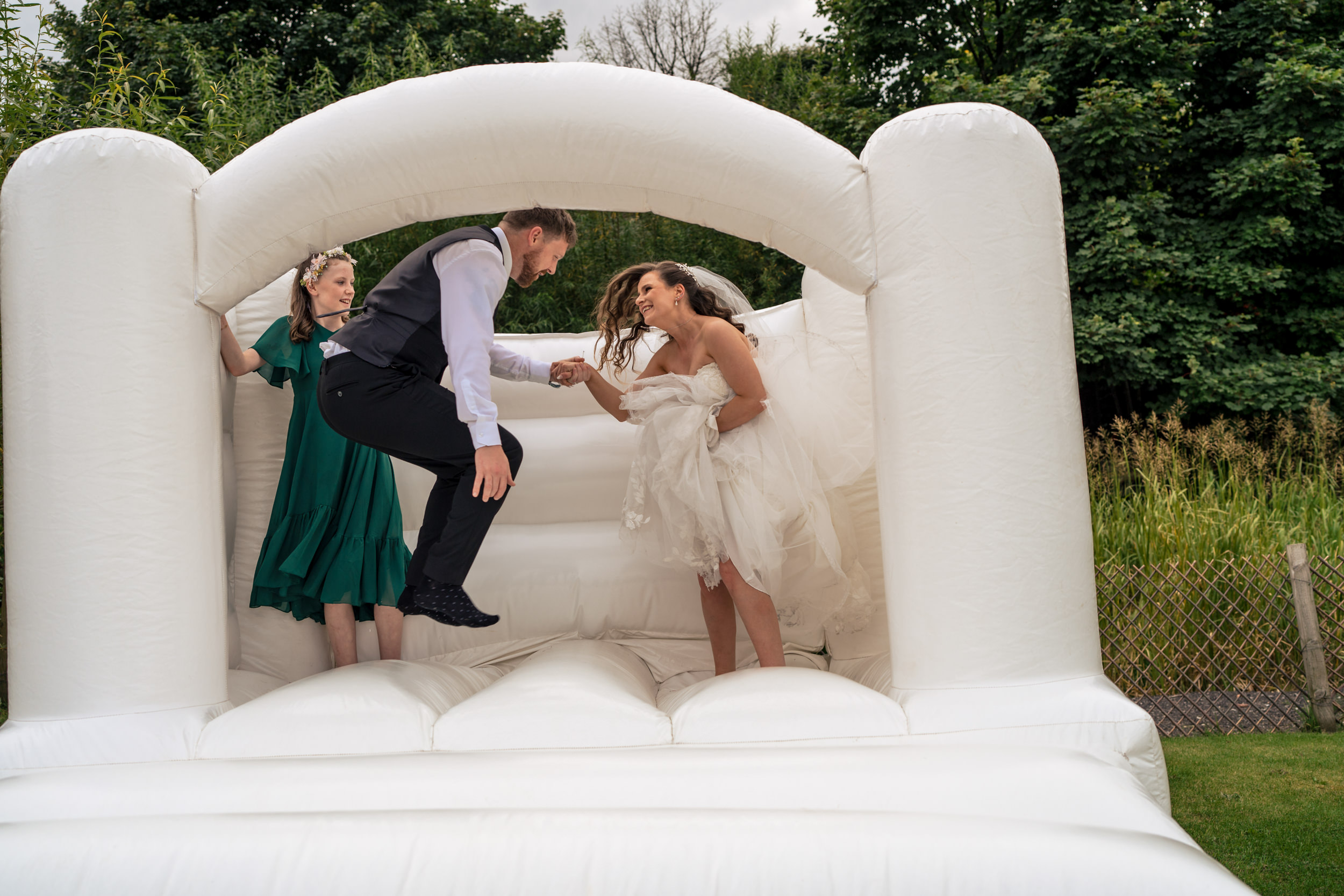 Bride and groom on the bouncy castle