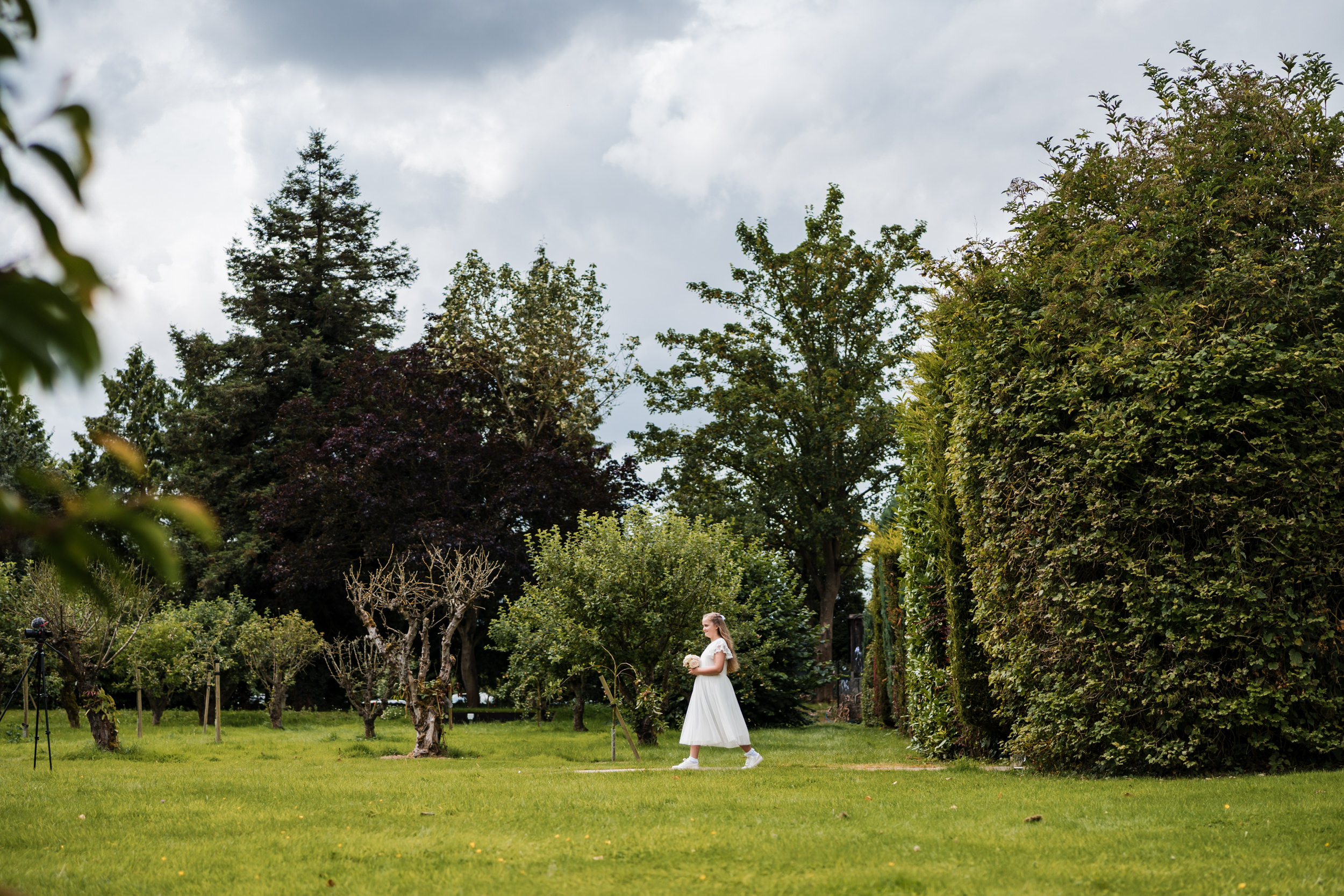 Bridesmaid walking to the ceremony area.