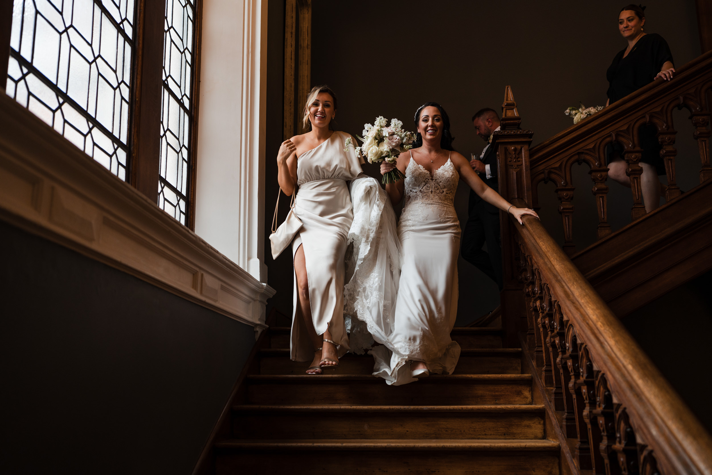 Bride and bridesmaids on the stairs at Thicket Priory