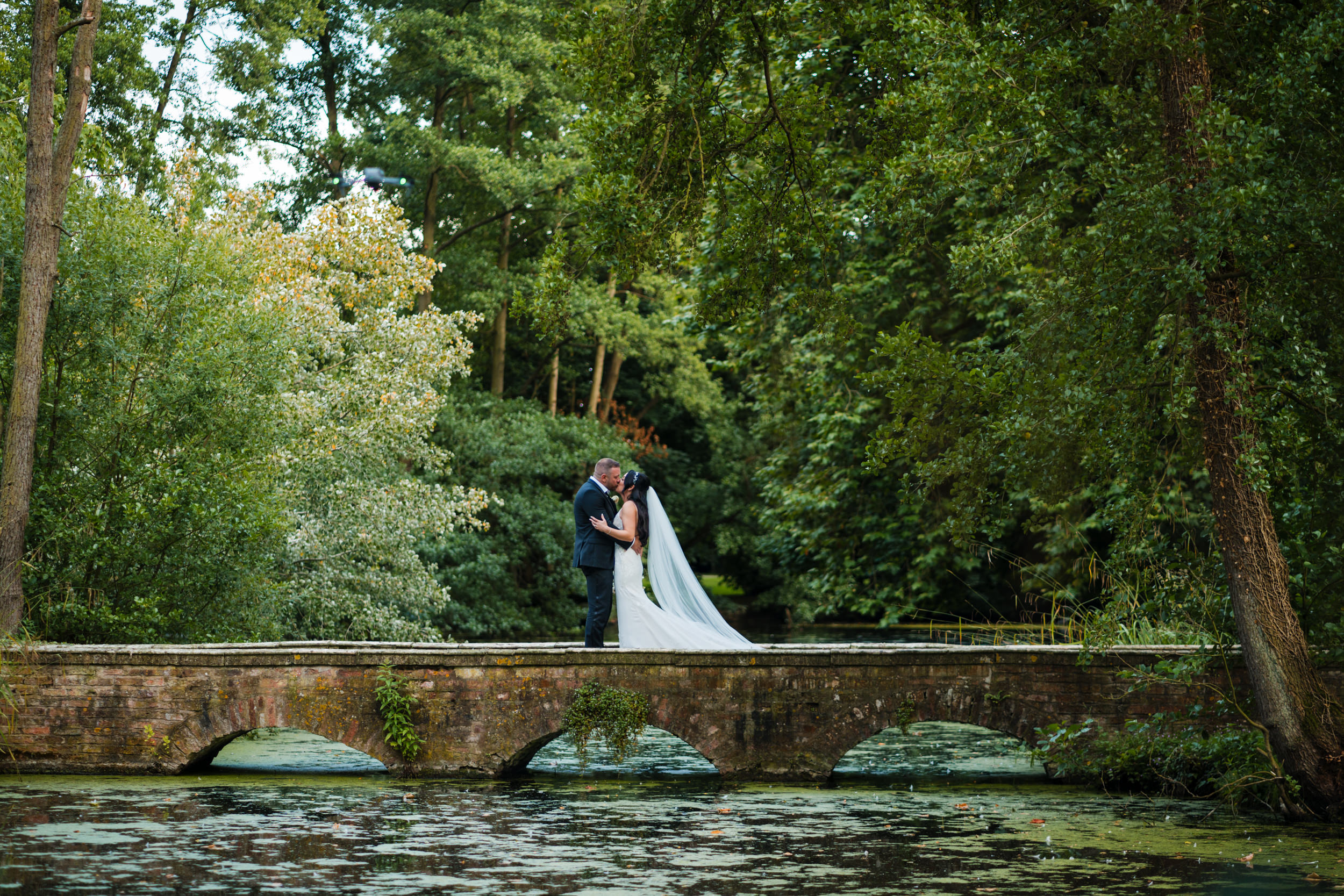 Bride and groom on one of the bridges at Thicket Priory