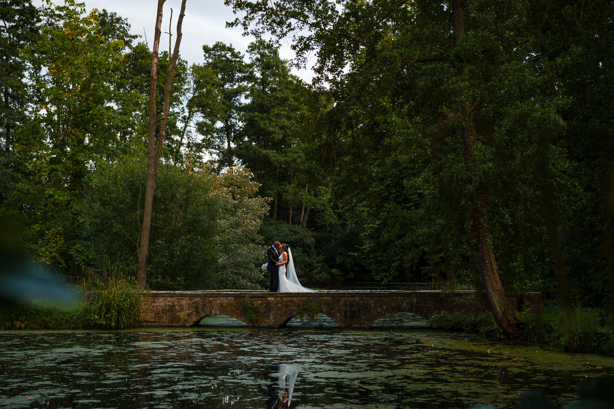 Bride and groom on one of the bridges at Thicket Priory